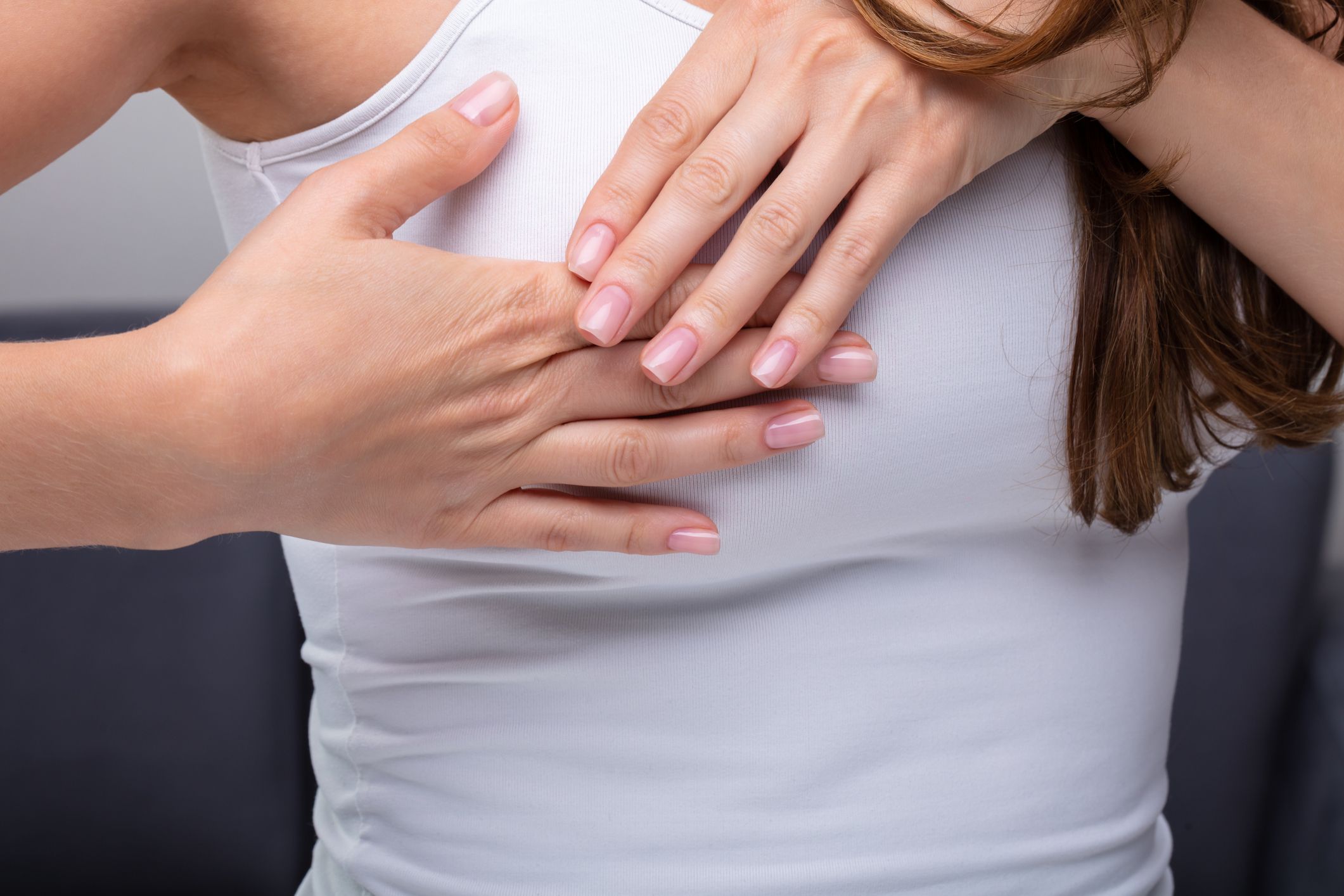 Close-up Of A Woman's Hand On Breast Suffering From Pain