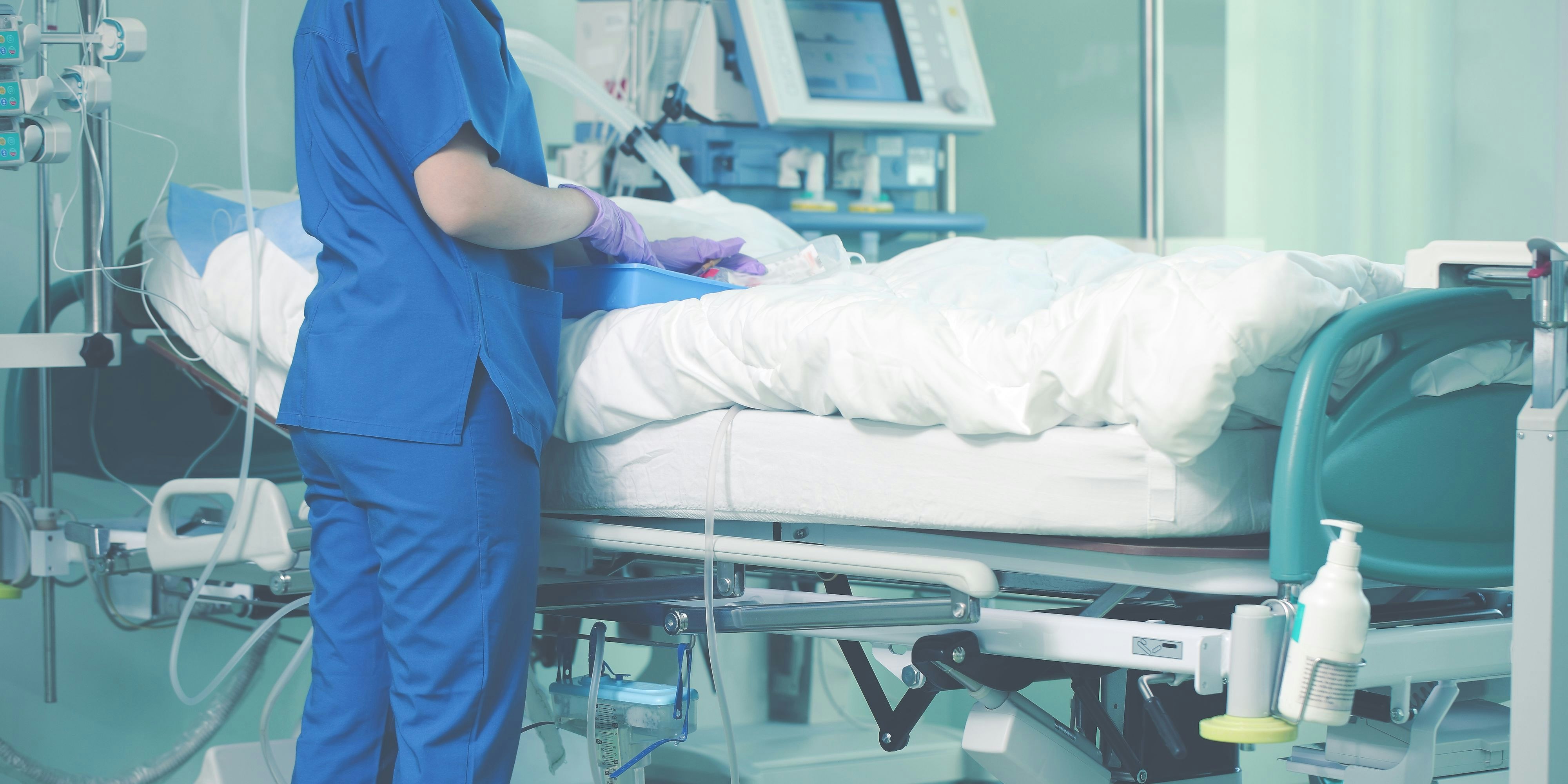 Medical nurse cares about patient in ICU.