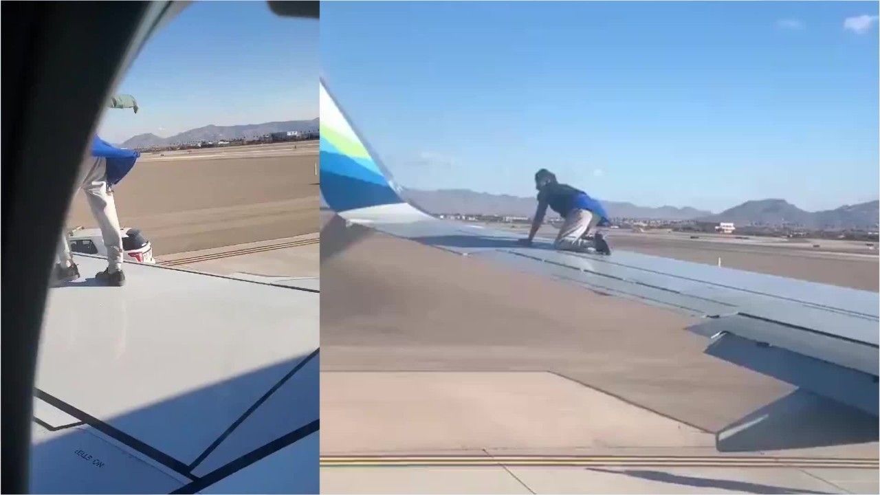 Der Mann kletterte auf den Flügel des Flugzeugs.