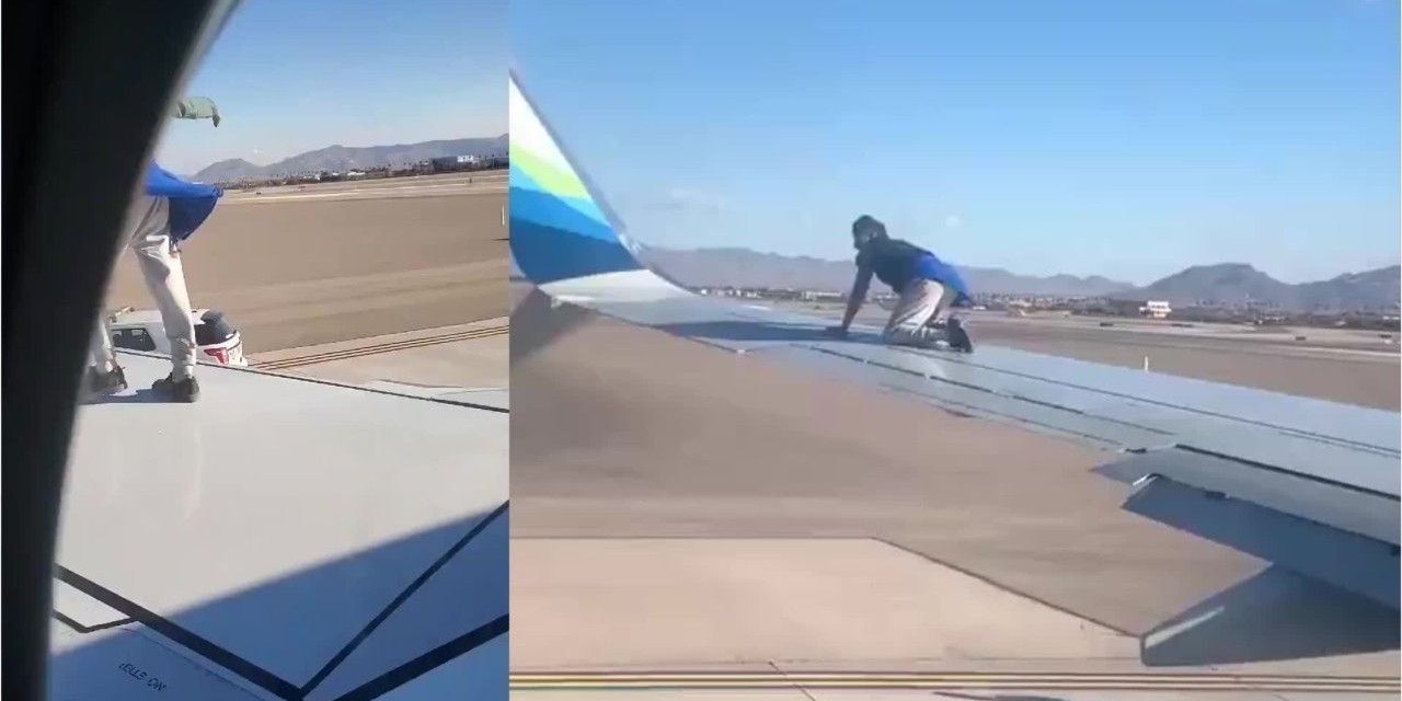 Der Mann kletterte auf den Flügel des Flugzeugs.