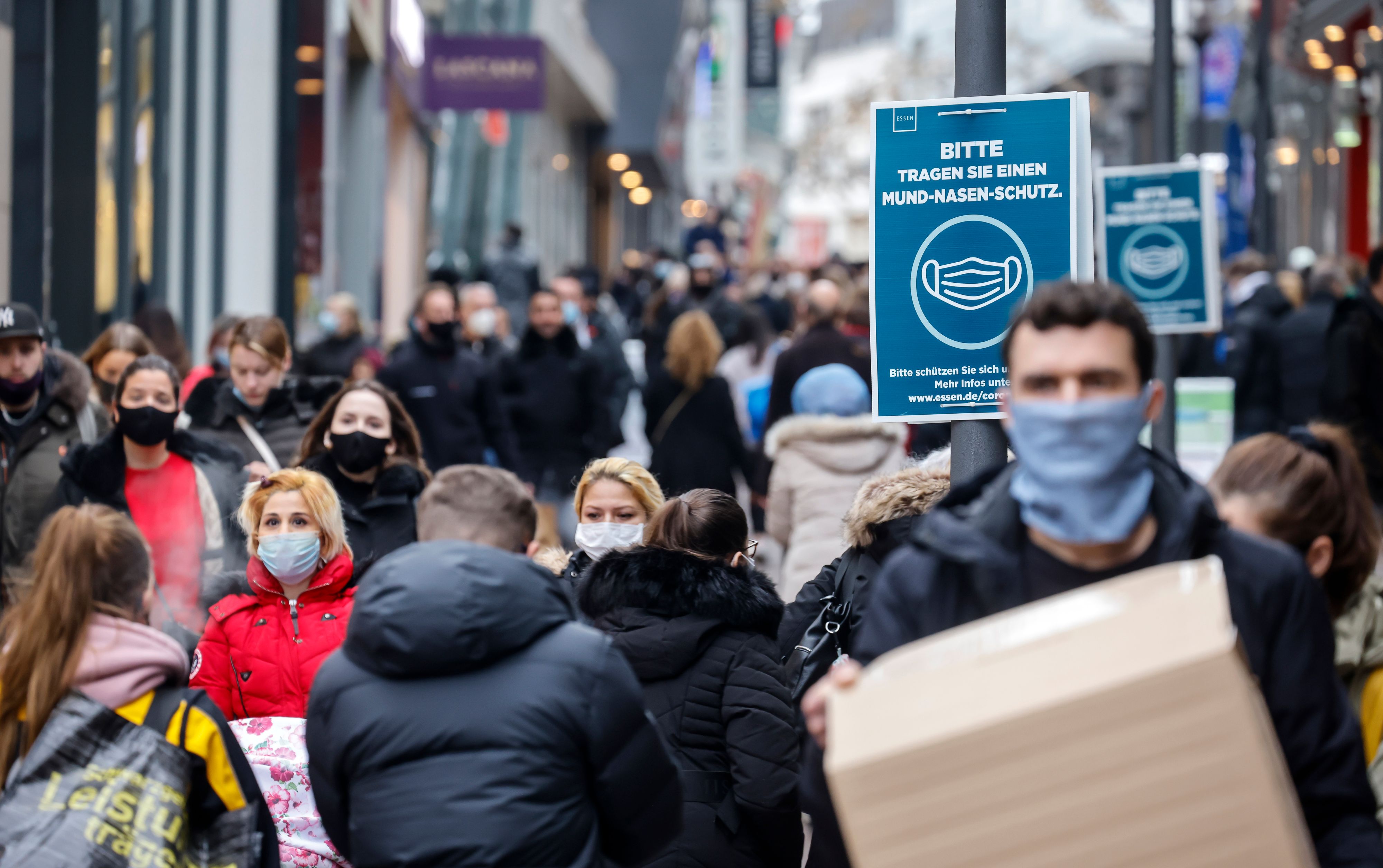 Menschen tragen im Freien eine Maske.