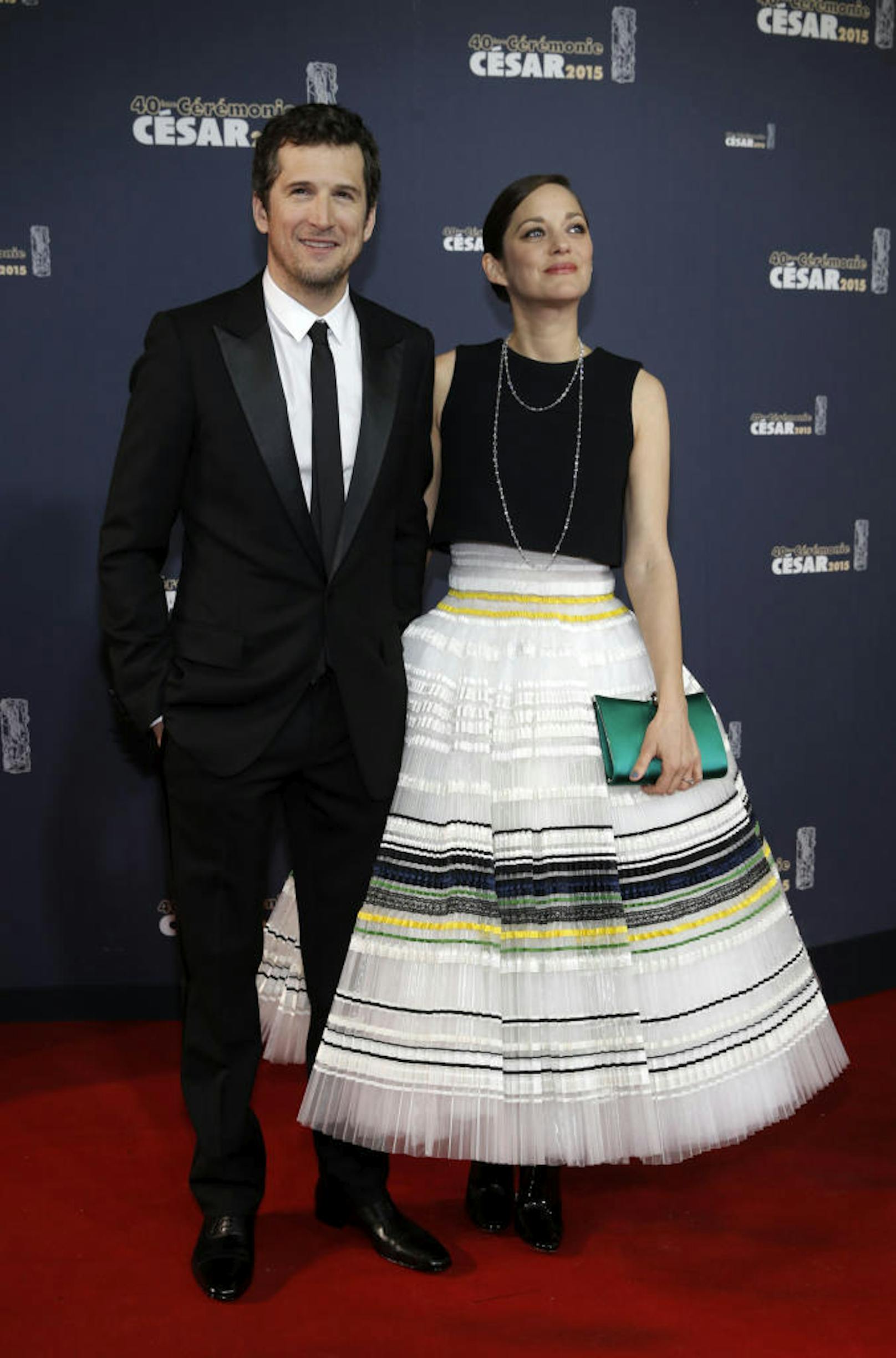 Actress Marion Cotillard (R) and actor Guillaume Canet pose as they arrive at the 40th Cesar Awards ceremony in Paris February 20, 2015.              REUTERS/Christian Hartmann (FRANCE  - Tags: ENTERTAINMENT)   - RTR4QGWF