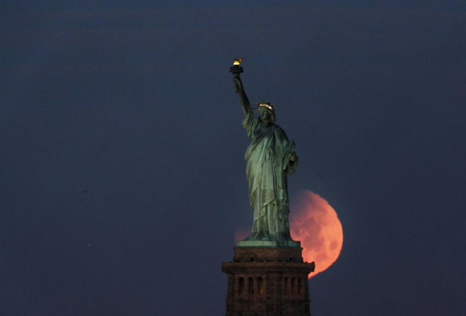 Mehrere Tausend Kilometer weiter im Norden gelang einem New Yorker Fotografen diese Schnappschuss des Mondes vor der Freiheitsstatue.