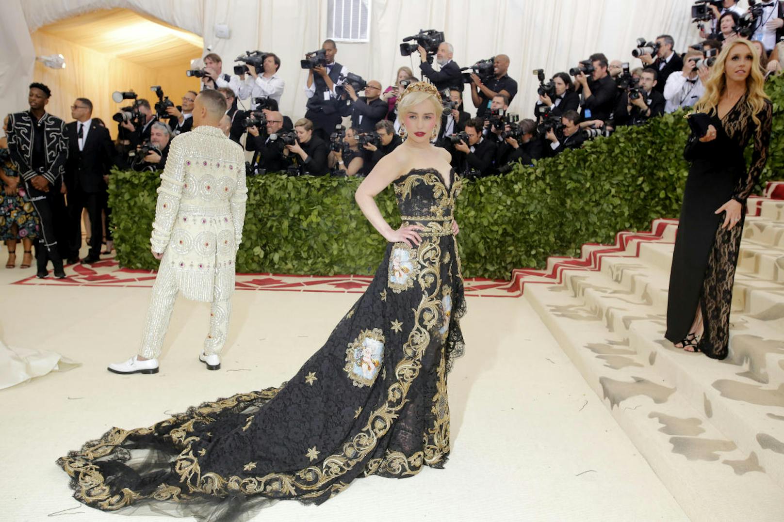 "Game of Thrones"-Star Emilia Clarke sah in einem einem schwarzes Spitzenkleid von Dolce & Gabbana mit aufwendiger Goldstickerei und Cherub-Motiven umwerfenden aus. Ihre hellblonden Haare hielt die Schauspielerin mit einer Krone in Zaum.
