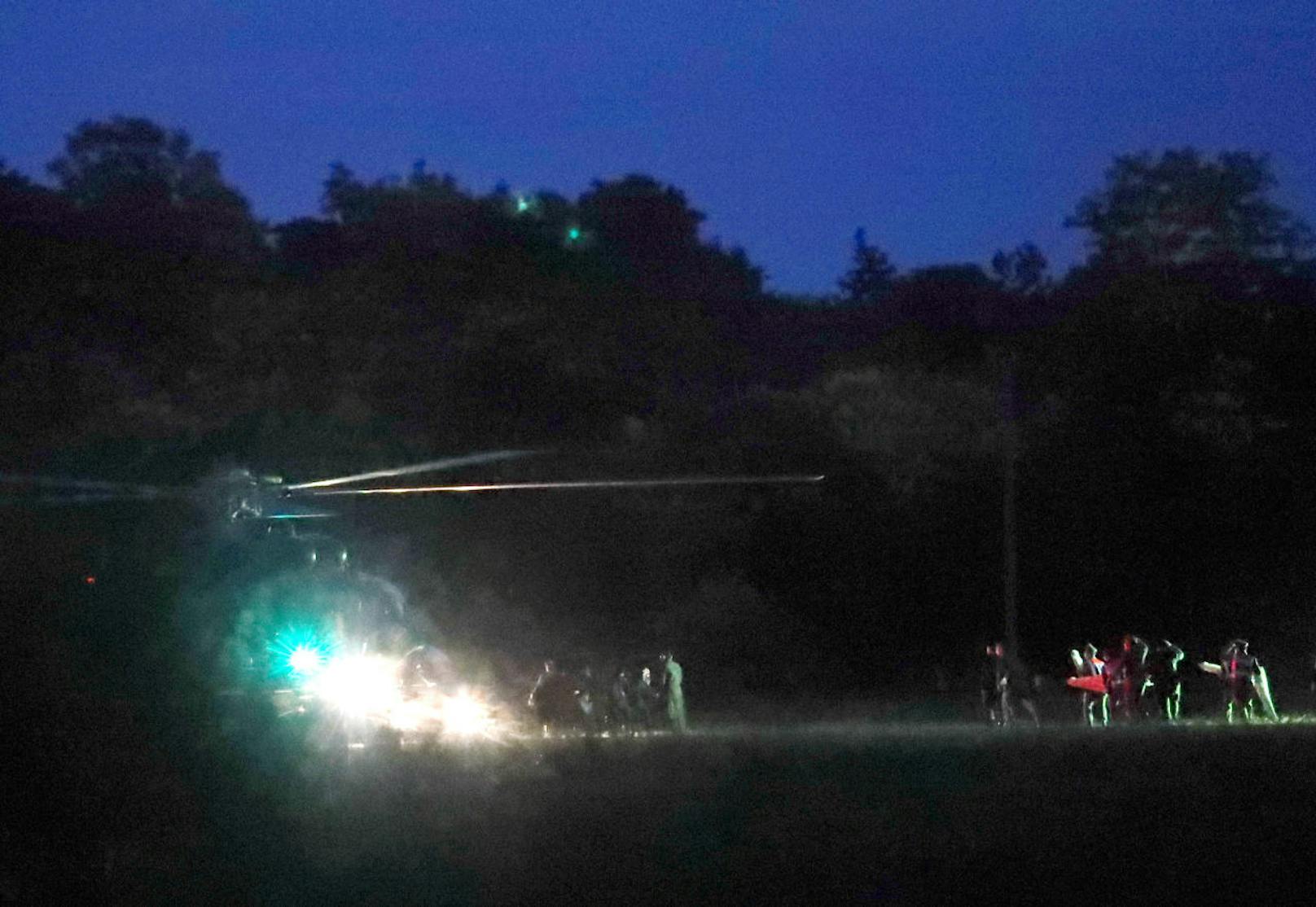 epa06873696 Thai medics and police officers evacuate children after rescued from Tham Luang cave before heading to hospital, at a helicopter pad in Chiang Rai province, Thailand, 08 July 2018. The first six children have been confirmed to rescue on 08 July 2018 after have been trapped in Tham Luang cave since 23 June 2018.  EPA-EFE/RUNGROJ YONGRIT