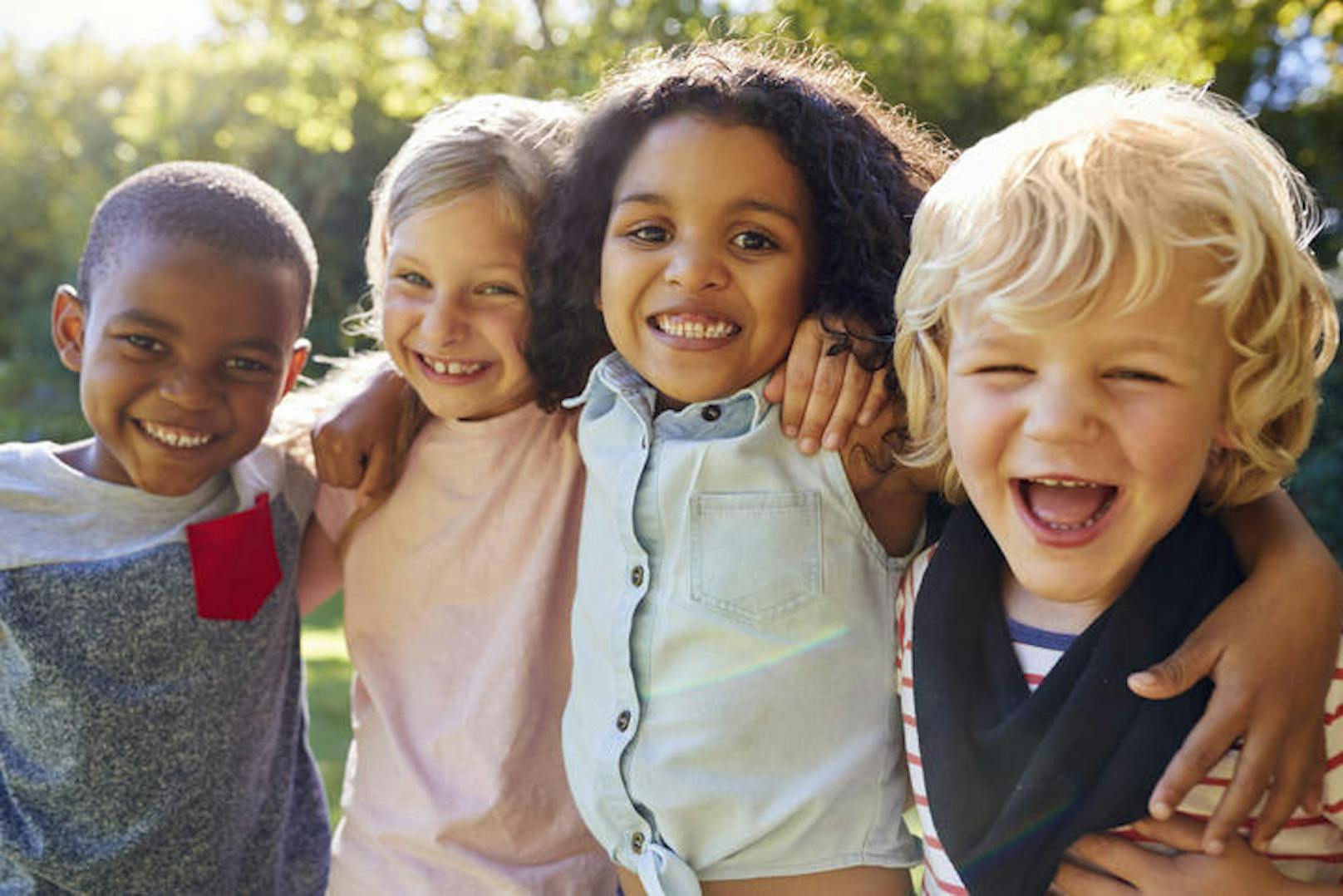 Four kids hanging out together in the garden