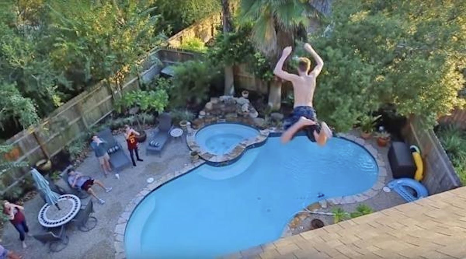 Junge Touristen versuchen, vom Balkon ihres Hotels in den Pool zu springen.
