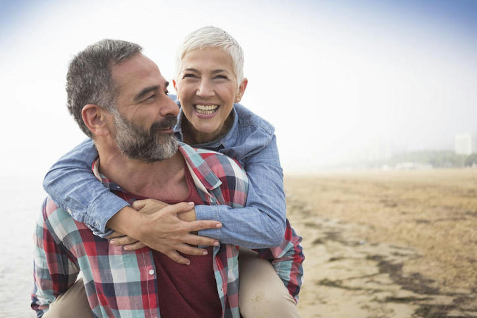 Mature playful couple at beach