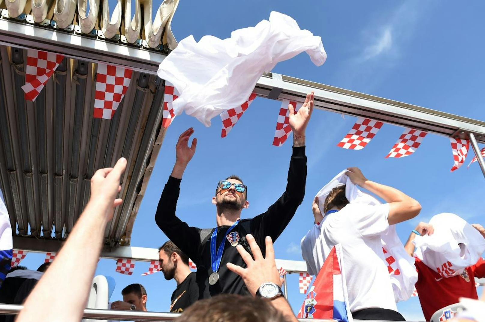 Die kroatischen Kicker werfen den Fans Shirts und Trikots zu.