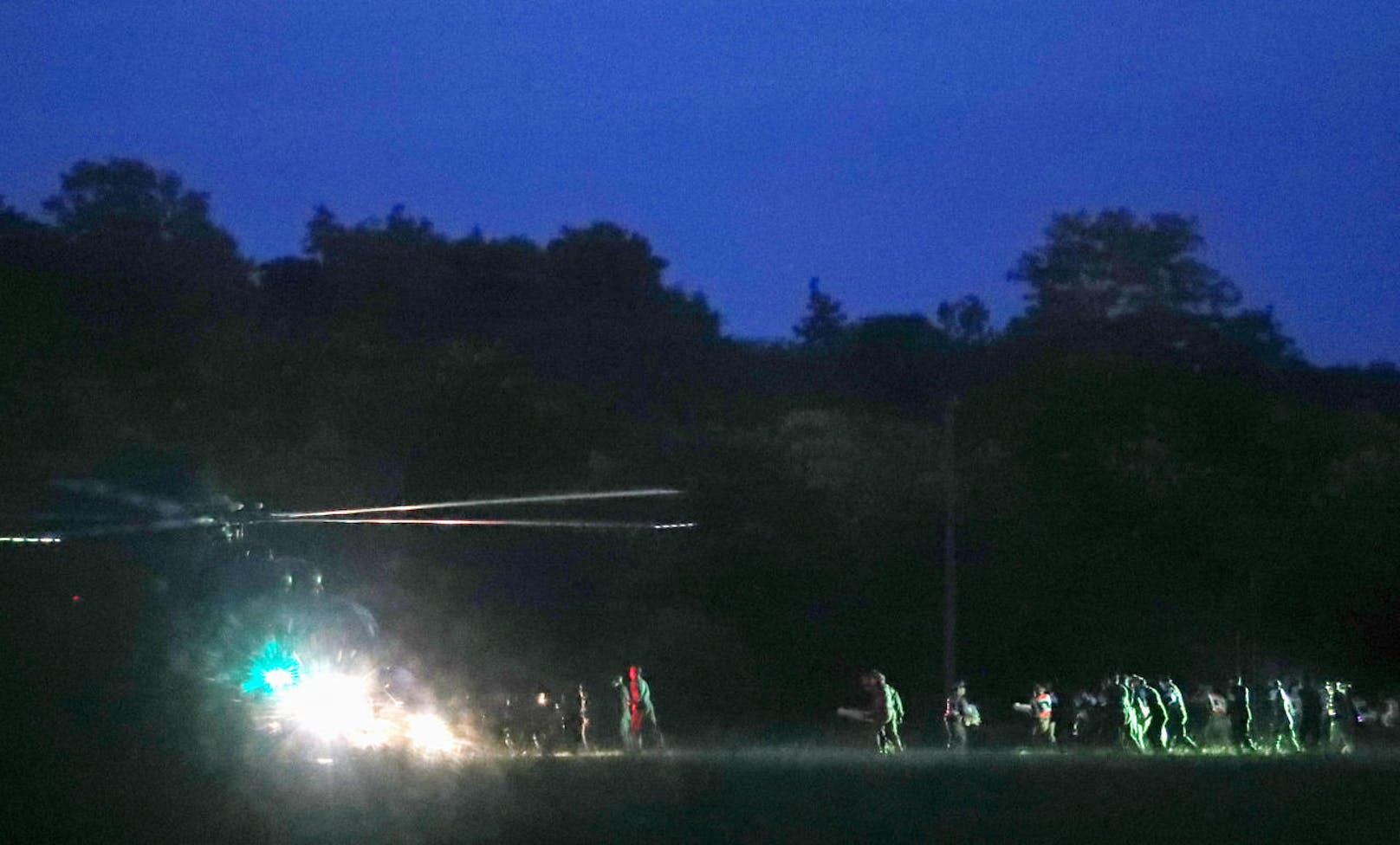epa06873720 Thai medics and police officers evacuate the first two children with a helicopter after rescued from Tham Luang cave before heading to hospital, at a helicopter pad in Chiang Rai province, Thailand, 08 July 2018. Members of a children soccer team and their assistant coach who have been trapped in Tham Luang cave since 23 June 2018 have been rescued on 08 July 2018.  EPA-EFE/RUNGROJ YONGRIT