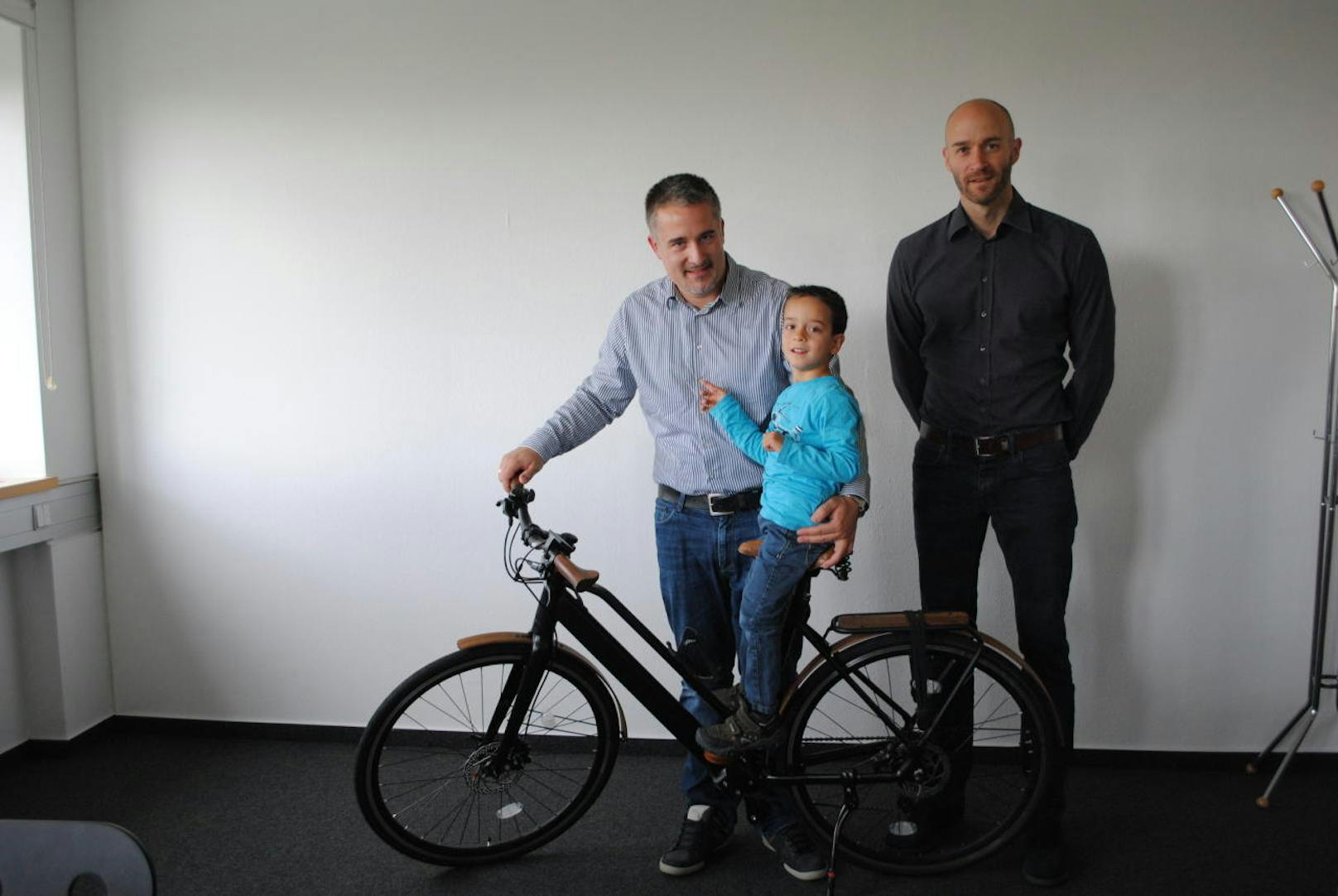 Gewinner der Geero E-Bike-Verlosung Bernhard (ganz links) mit seinem Sohn und Christoph Schreiner von Niceshops, die das E-Bike zur Verfügung gestellt haben.