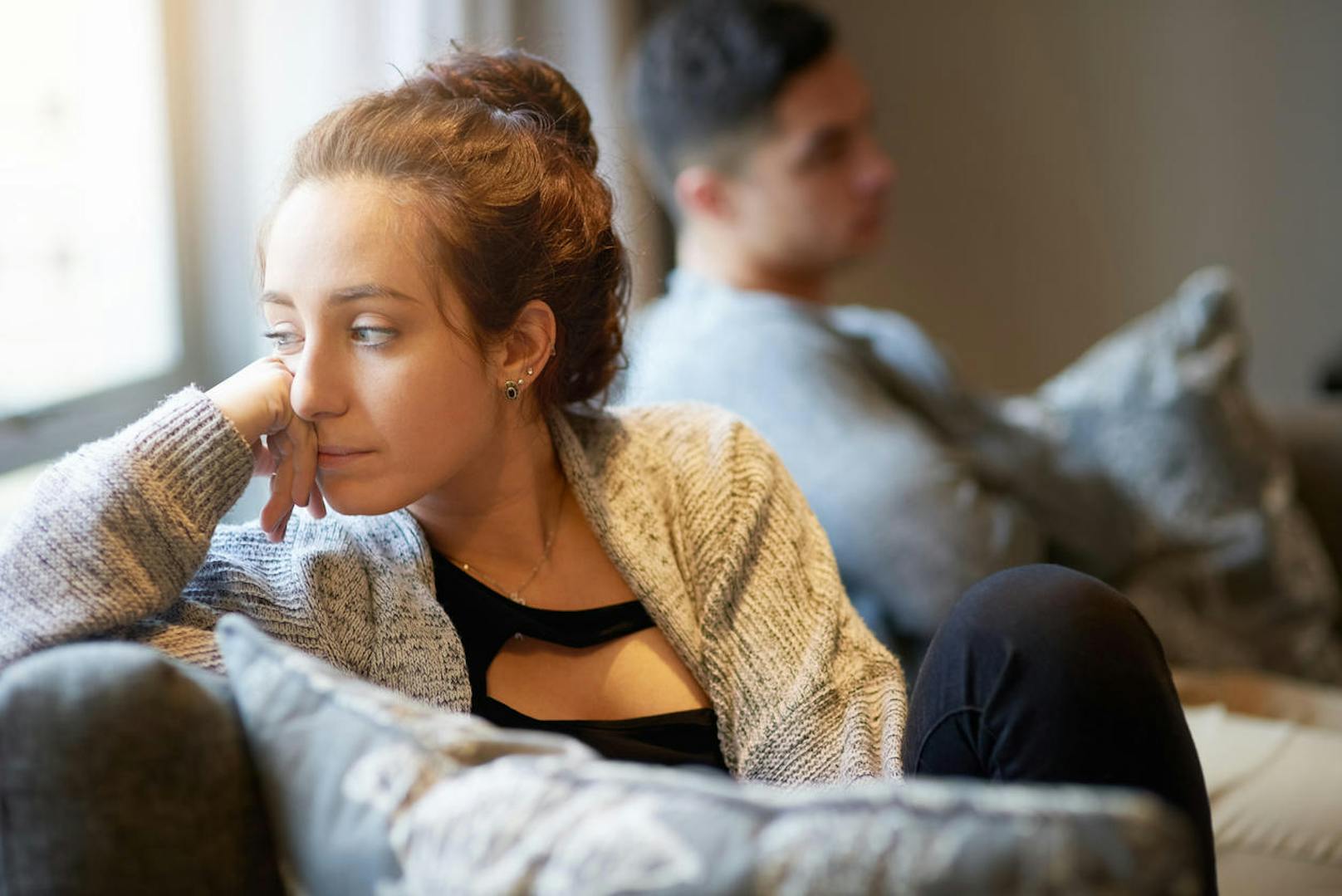 Shot of a young woman looking despondent after a fight with her boyfriend