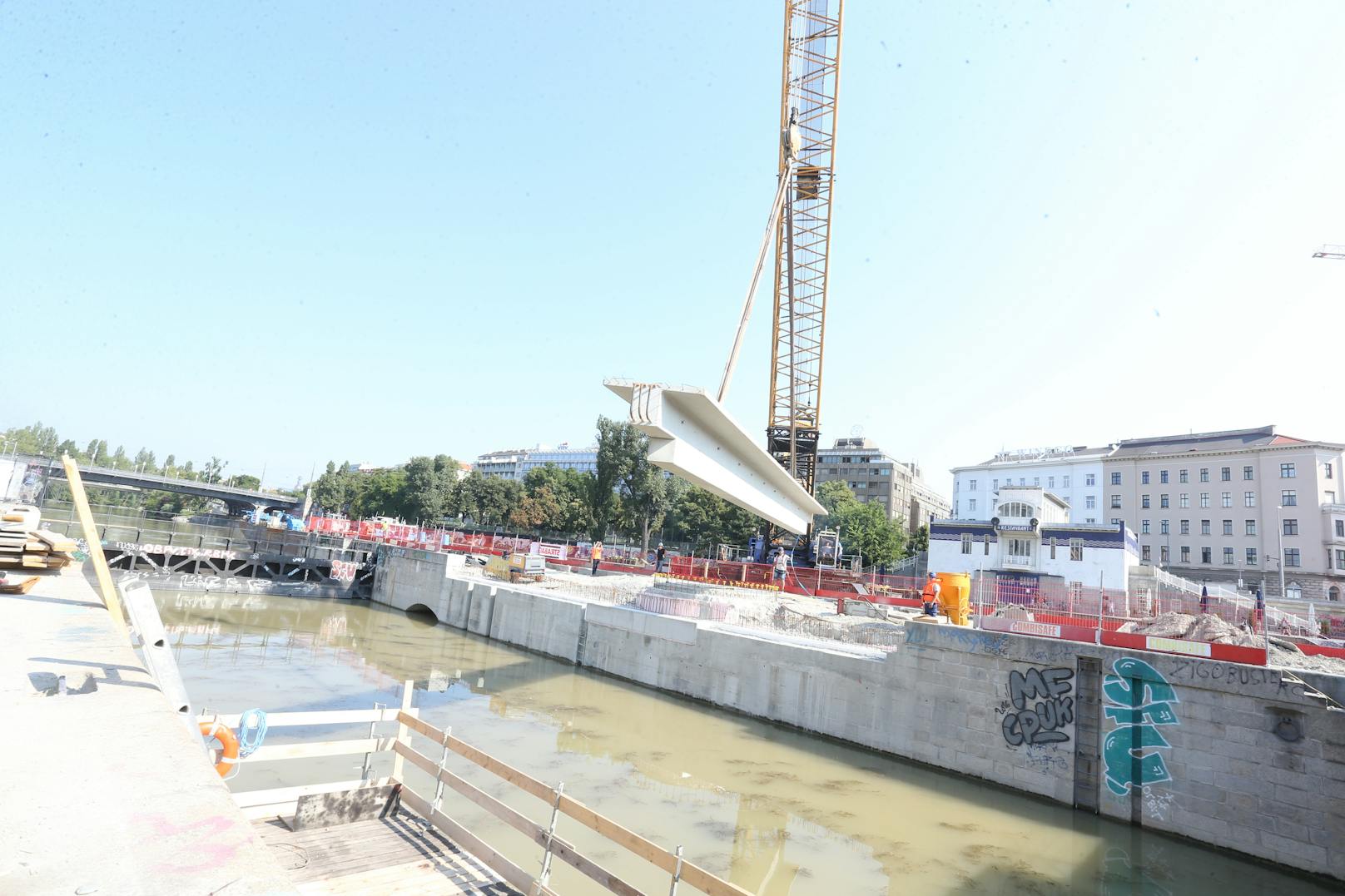 Im Zuge der Bauarbeiten für die Schwimmenden Gärten am Wiener Donaukanal wurden am Montag Brückenbauteile mit einem Großraumschubleichter über den Donaukanal angeliefert und per Kran an den Kai bzw. die Kaiserbadschleuse versetzt. Am Mittwoch kommt die zweite "Fuhre".