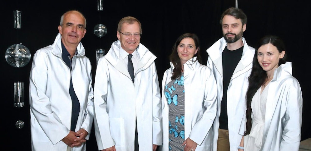 Die Verantwortlichen der Ausstellung "Sinnesrausch" schlüpften gemeinsam mit Landeshauptmann Thomas Stelzer in reflektiertende Mäntel, die Teil eines Projekts der Künstlerin Anneliese Strba sind.