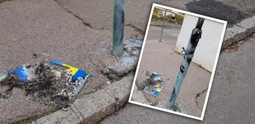 Das Plakat ist Asche, die Laterne kaputt.