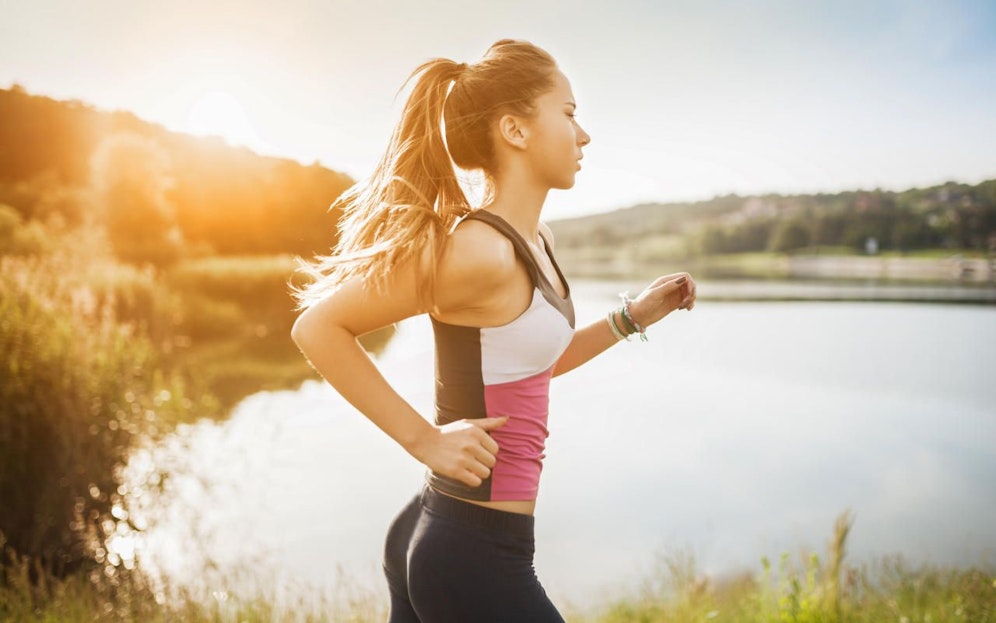Beautiful young woman run in nature