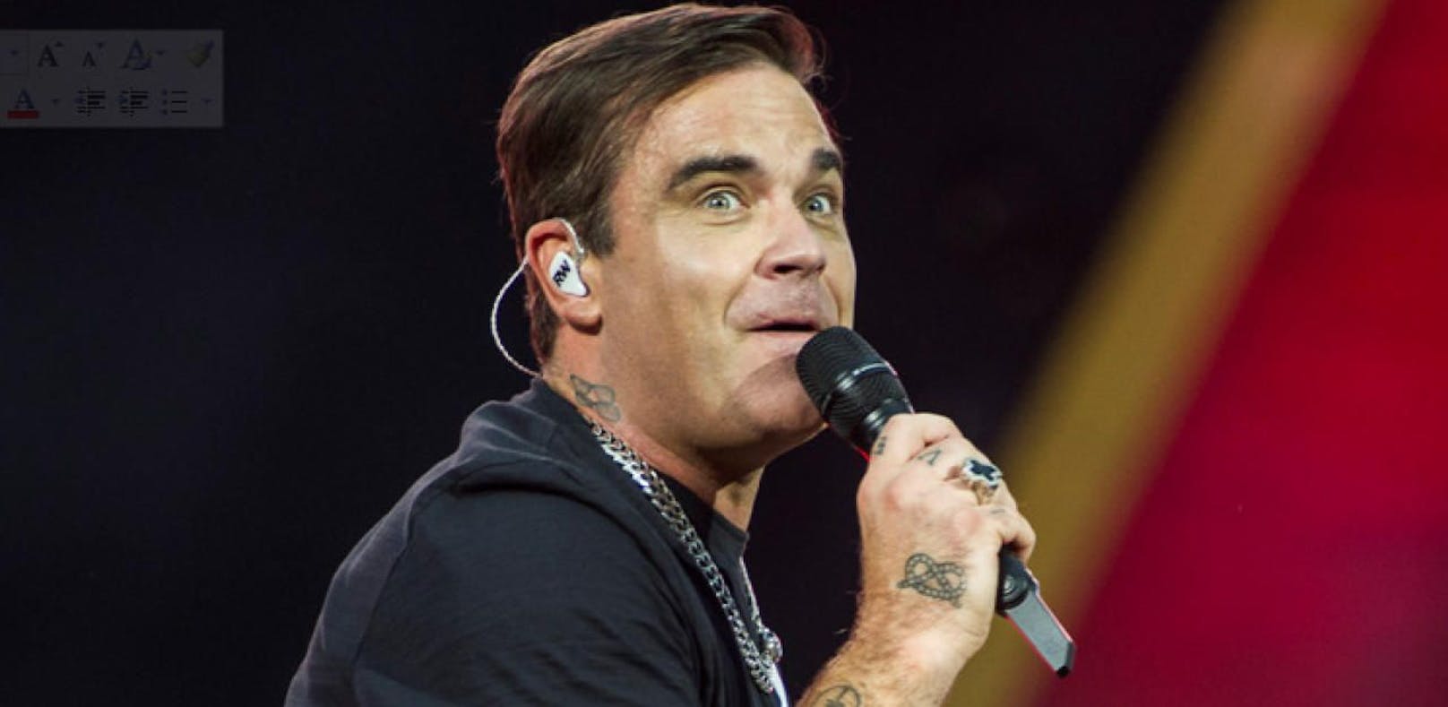 Video: Robbie Williams signiert "kleine Brüste"