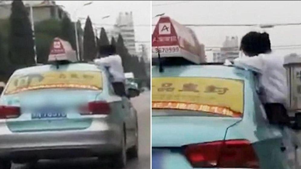 Man kann nicht hinschauen! Die Schülern macht ihre Hausaufgaben in aller Seelenruhe am Dach des Taxis. 