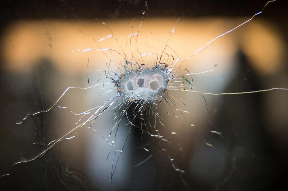Bullet holes from a Kalashnikov rifle in front windshield