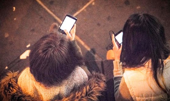 Zwei Jugendliche mit Smartphones.