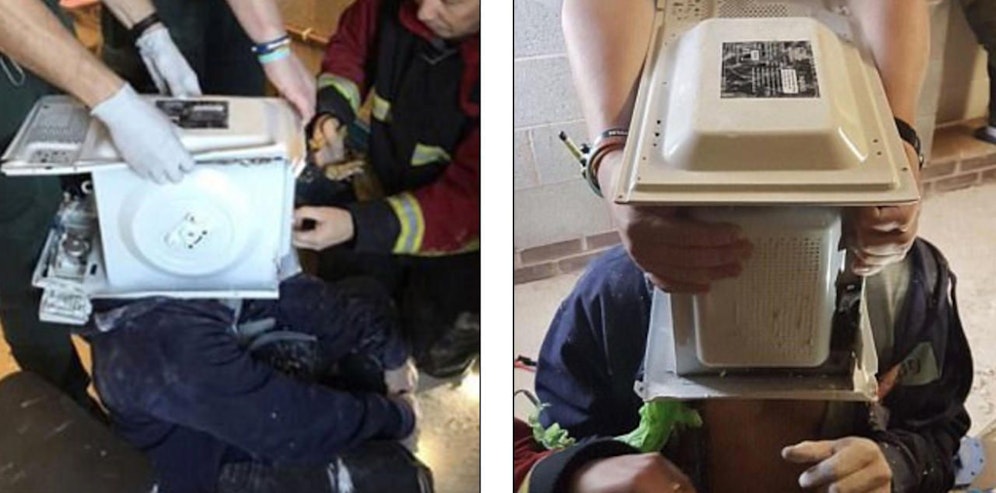 Mit vereinten Kräften: Die Feuerwehr brauchte eine Stunde, um den "kopflosen" Briten Jay Swingler (22) aus der Mikrowelle zu befreien. 