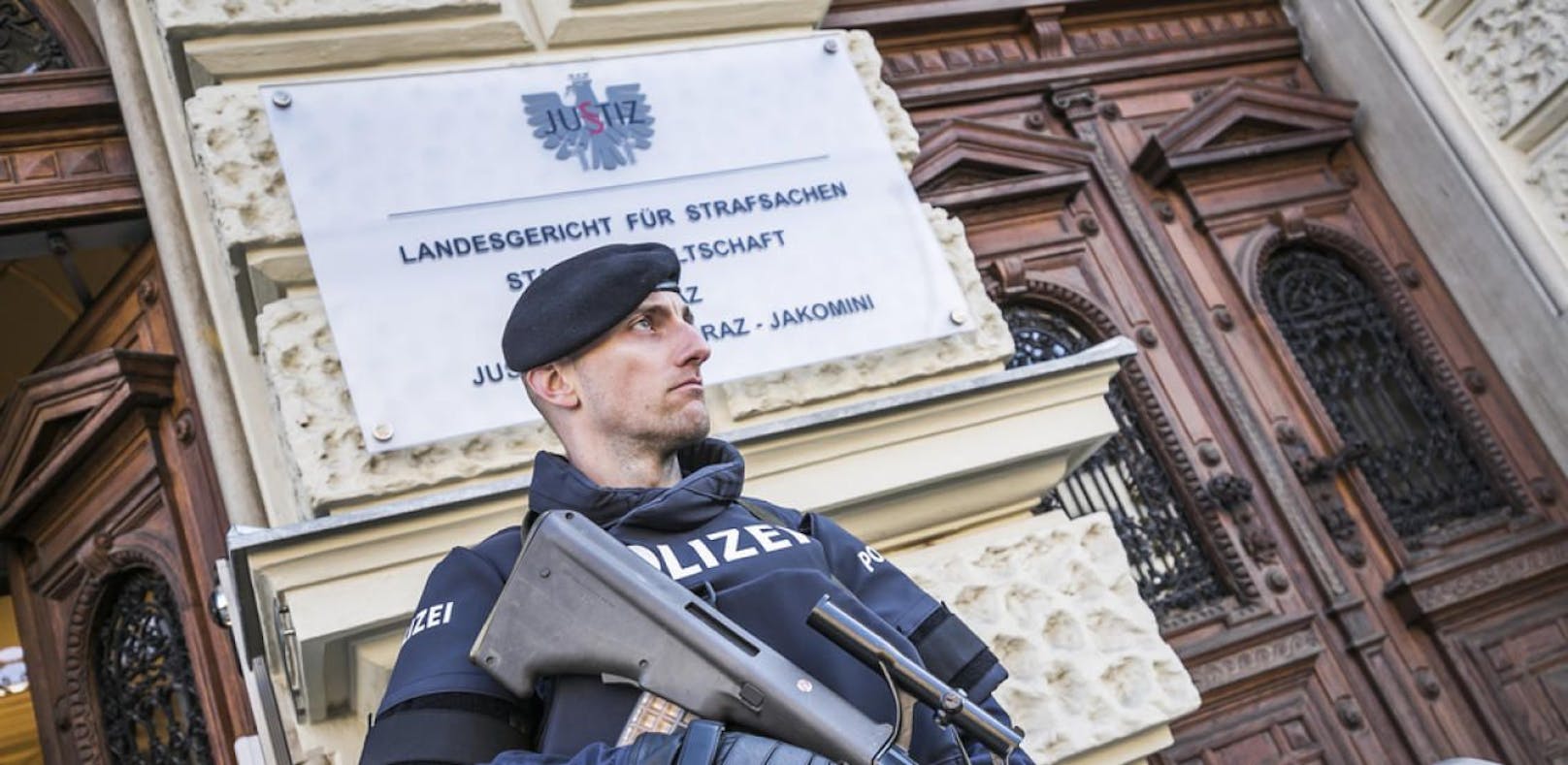 Schwer bewaffnete Polizisten bewachen das Landesgericht für Strafsachen in Graz.