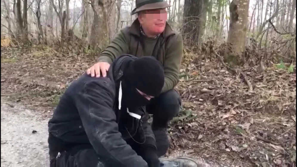 Einer der Tierschutzaktivisten vom Verein gegen Tierfabriken, die angeblich ins Gatter eingedrungen sein sollen, wird von einem Jagdschutzorgan bis zum Eintreffen der Polizei festgehalten.