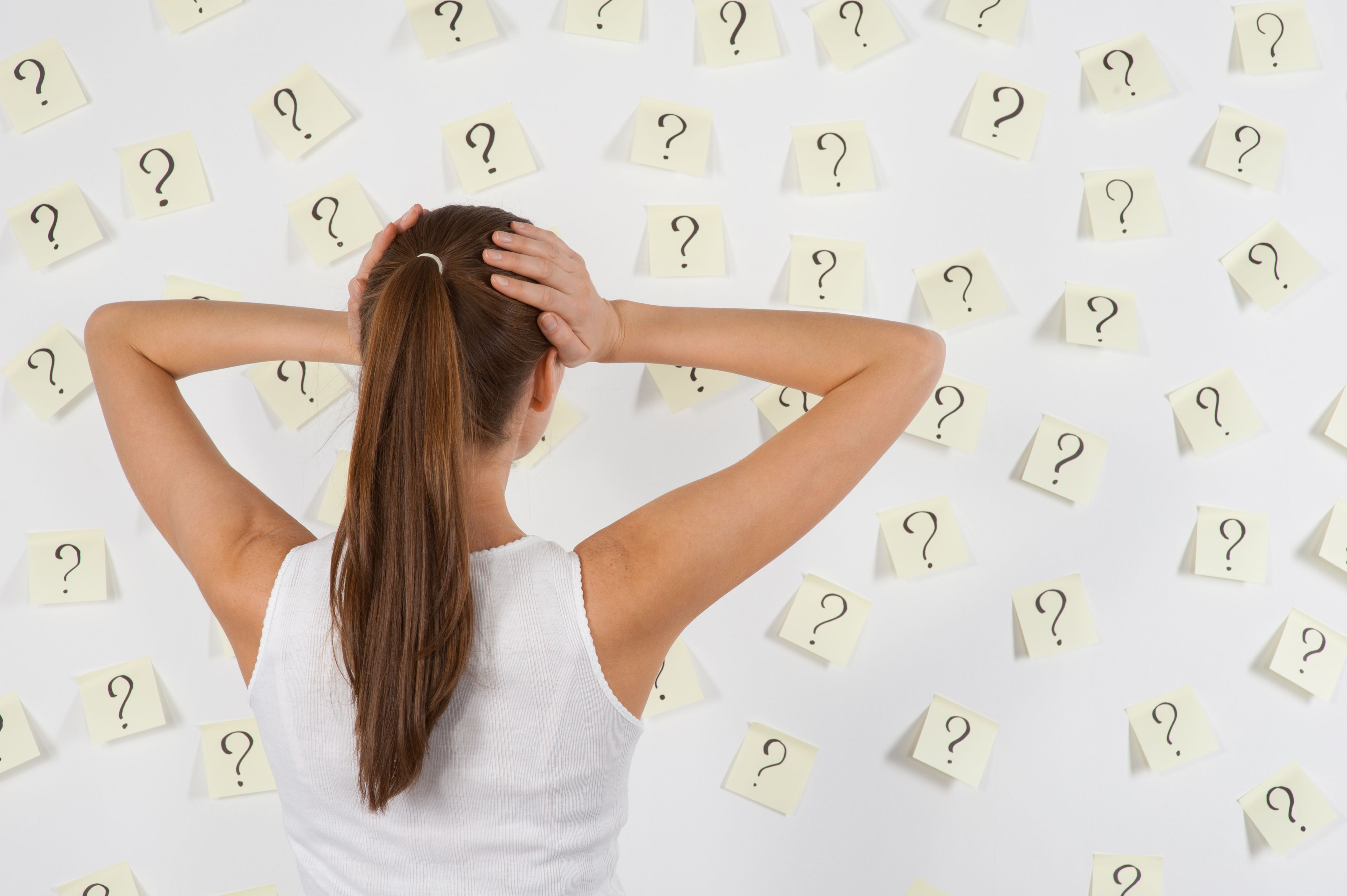 Young woman against stickers with questions