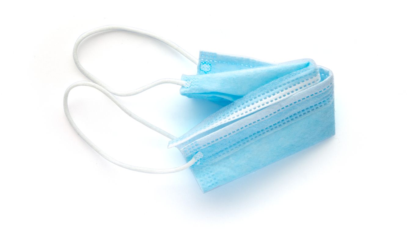 Used protective face mask on white background. image contains a clipping path