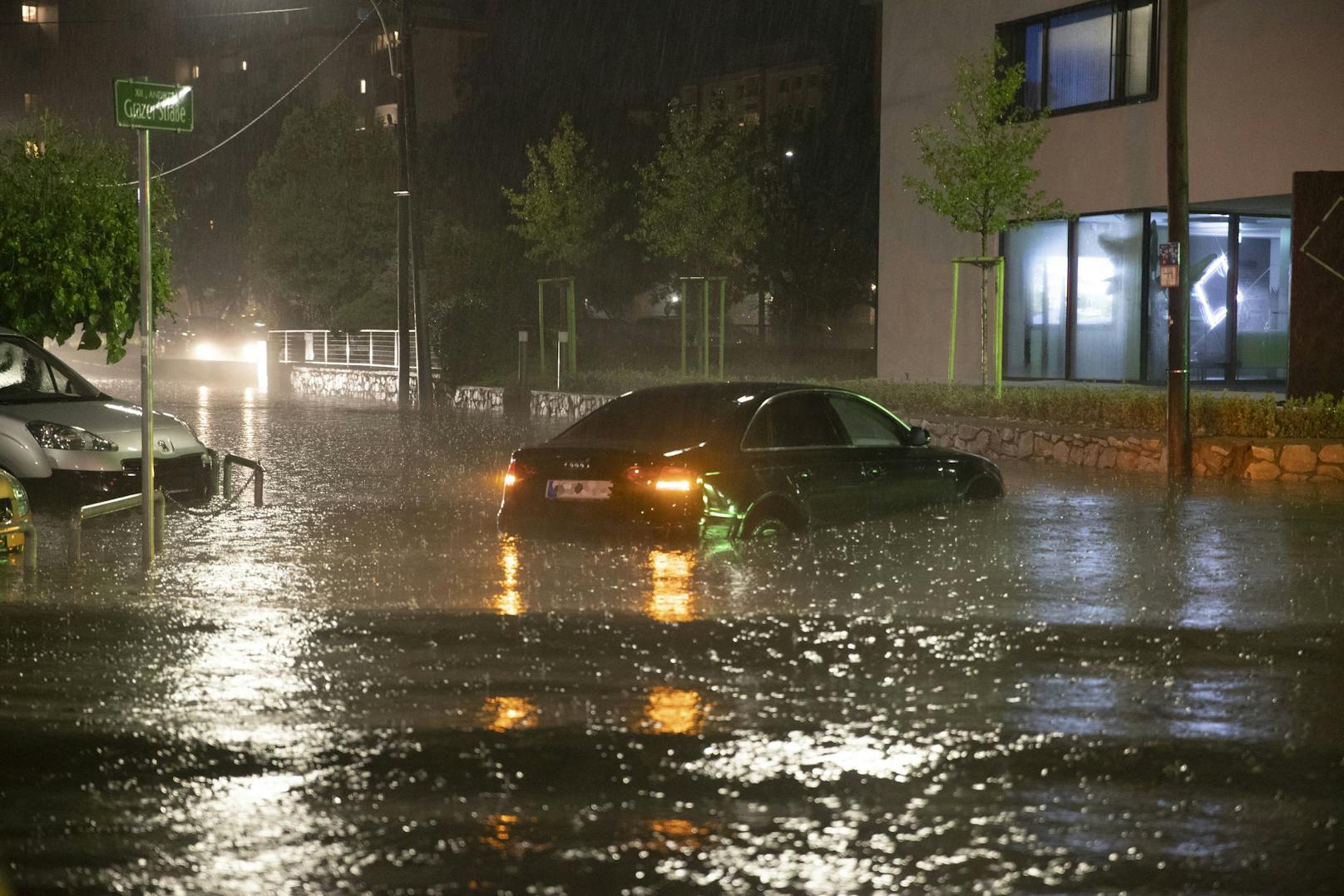 Ein Fahrzeug auf einer überfluteten Kreuzung nach schweren Unwettern am Freitag, 30. Juli 2021, in Graz