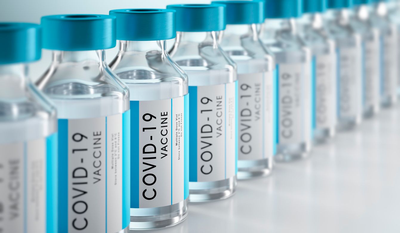 Row Covid-19 or Coronavirus vaccine flasks on white background
