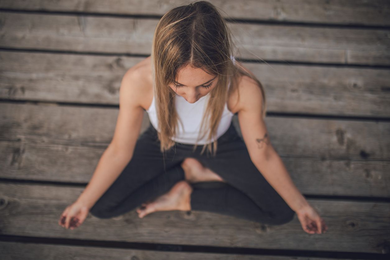 One woman, meditating outdoors alone.