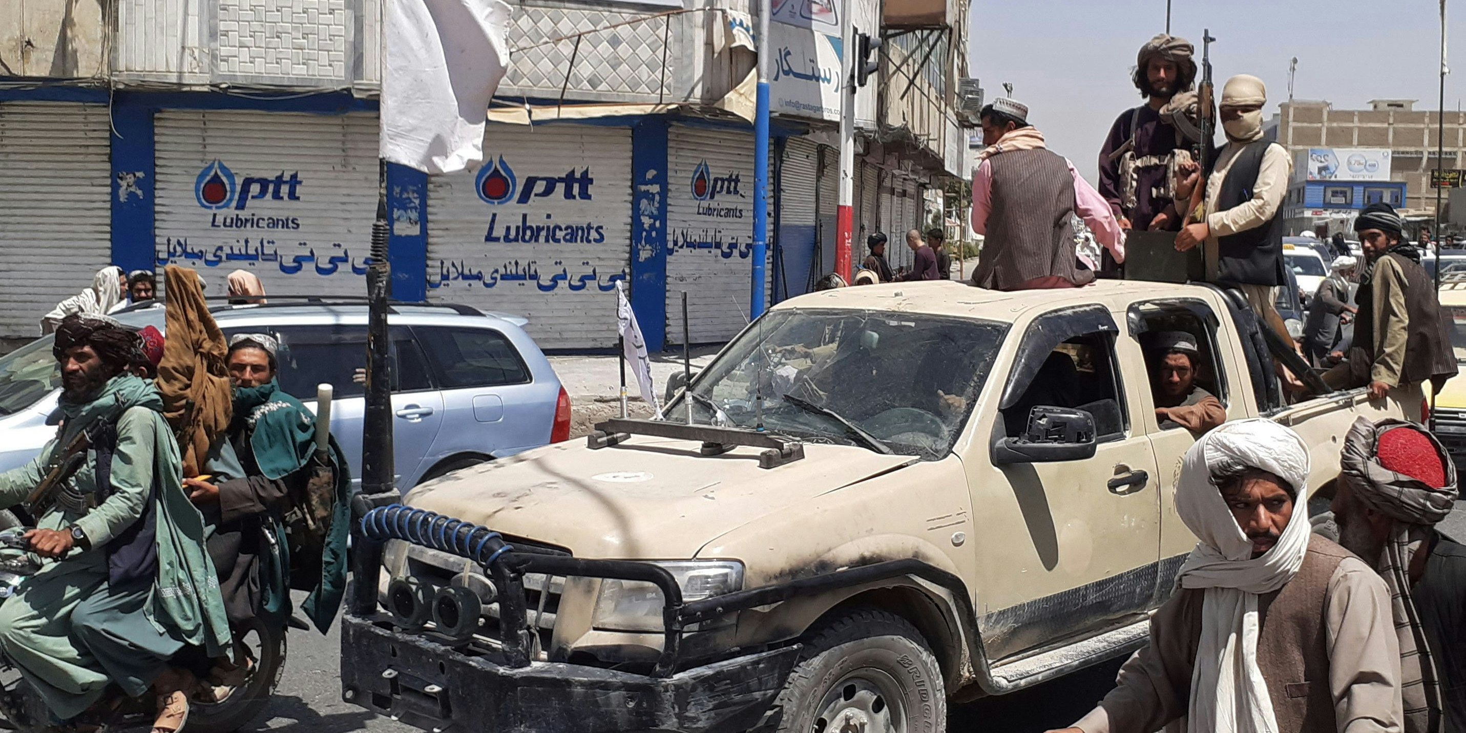 Taliban-Kämpfer mit einem erbeuteten Fahrzeug der afghanischen Armee