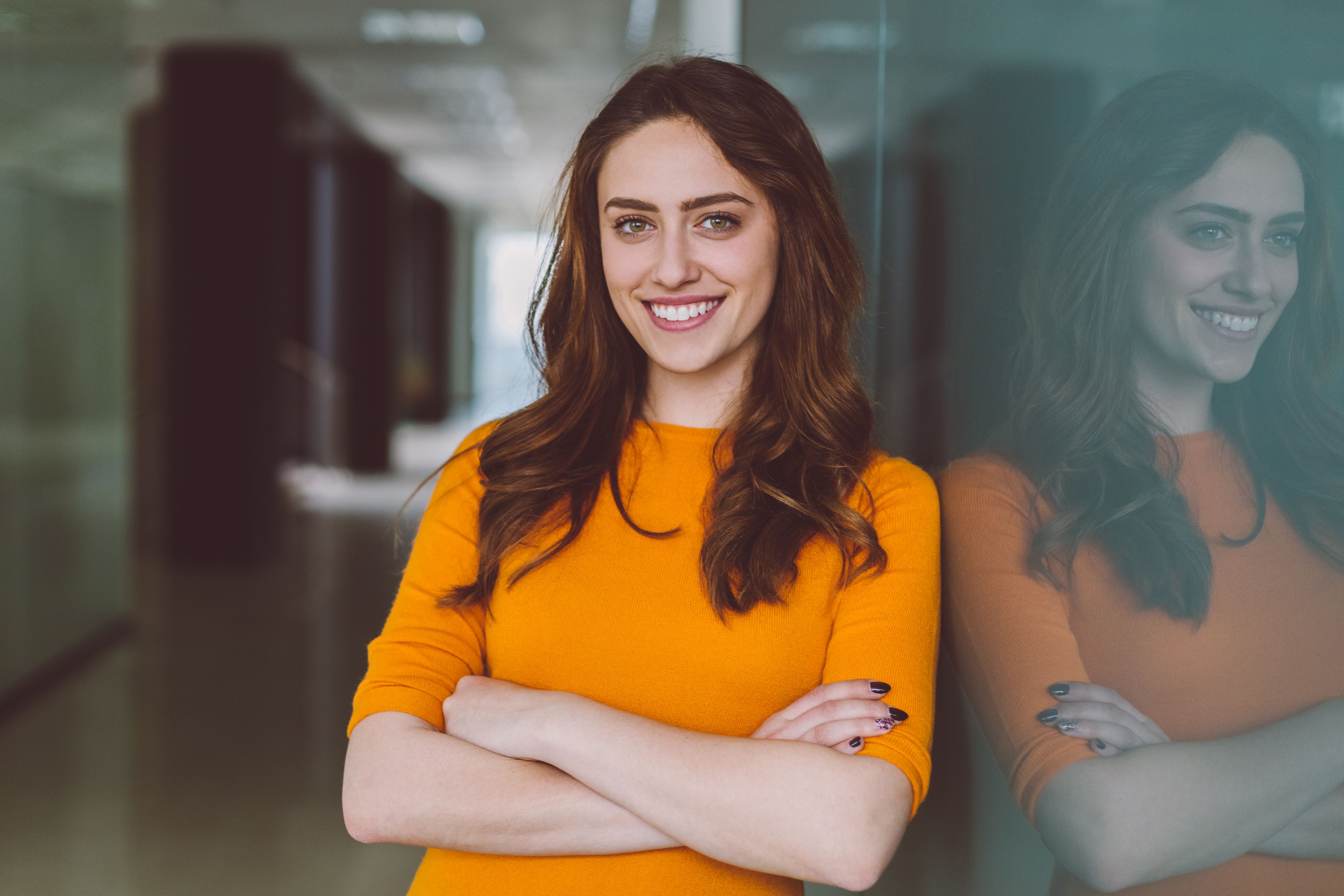Smiling woman in the office looking at camera