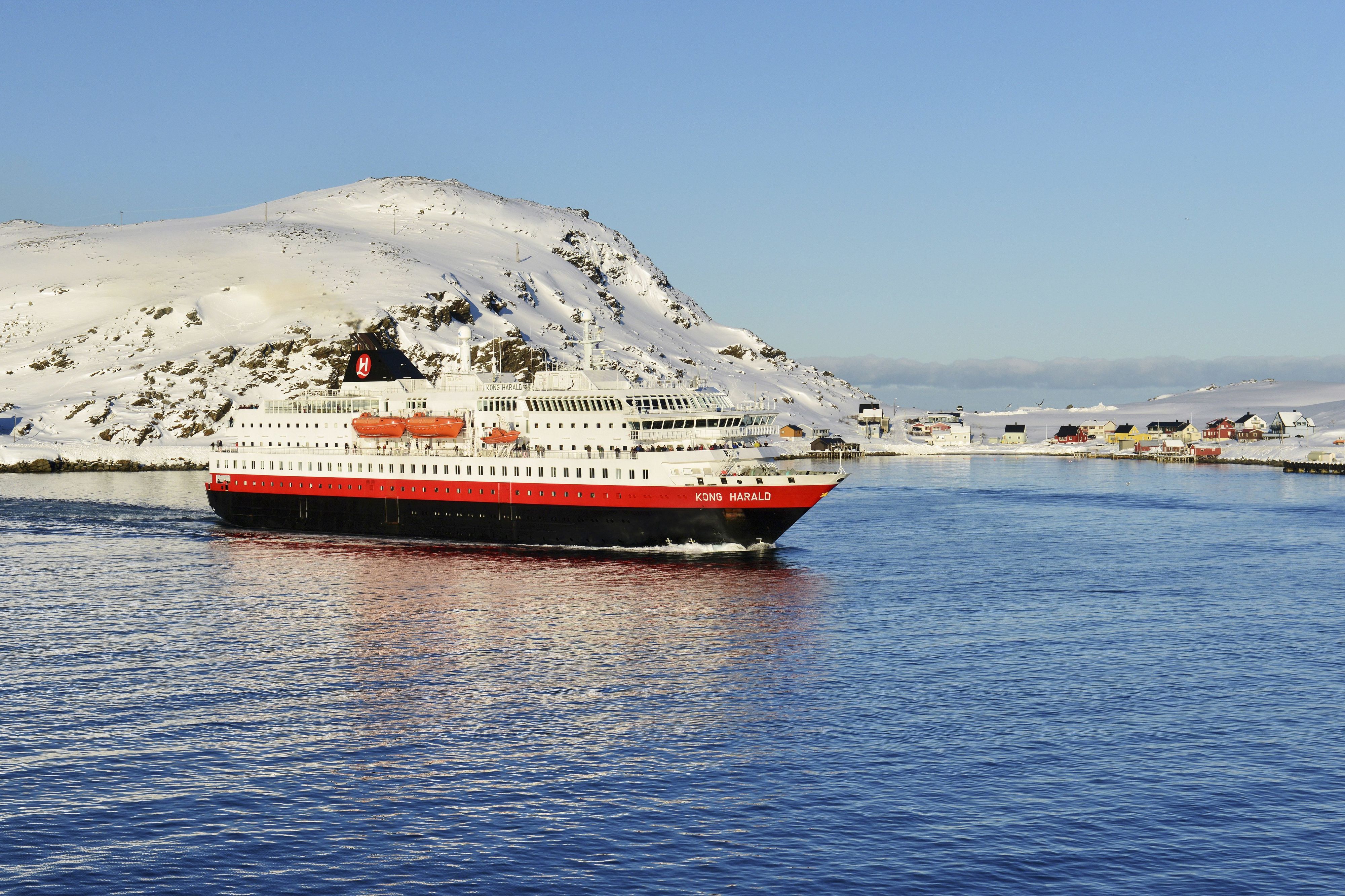 Hurtigruten's ship Kong Harald in front of the island Havøya picks up speed in direction south, 7 March 2017 | usage worldwide