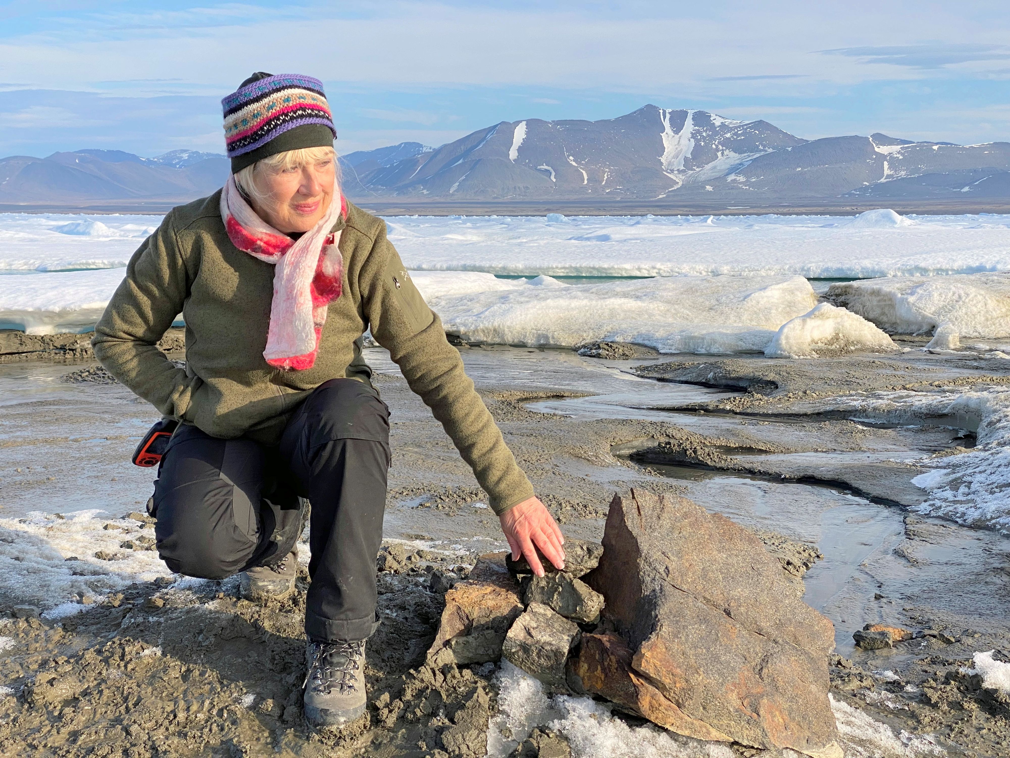 An undated handout image of Swiss entrepreneur Christiane Leister, creator of the Leister Foundation that financed an expedition which discovered a tiny island off the coast of Greenland which they say is the world's northernmost point of land, in front of a cairn in which expedition members left a message with details of their visit. Julian Charriere/via REUTERS THIS IMAGE HAS BEEN SUPPLIED BY A THIRD PARTY. MANDATORY CREDIT. NO RESALES. NO ARCHIVES