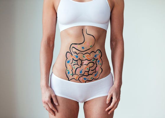 Female with an illustration on her abdomen of intestines with colourful bacteria
