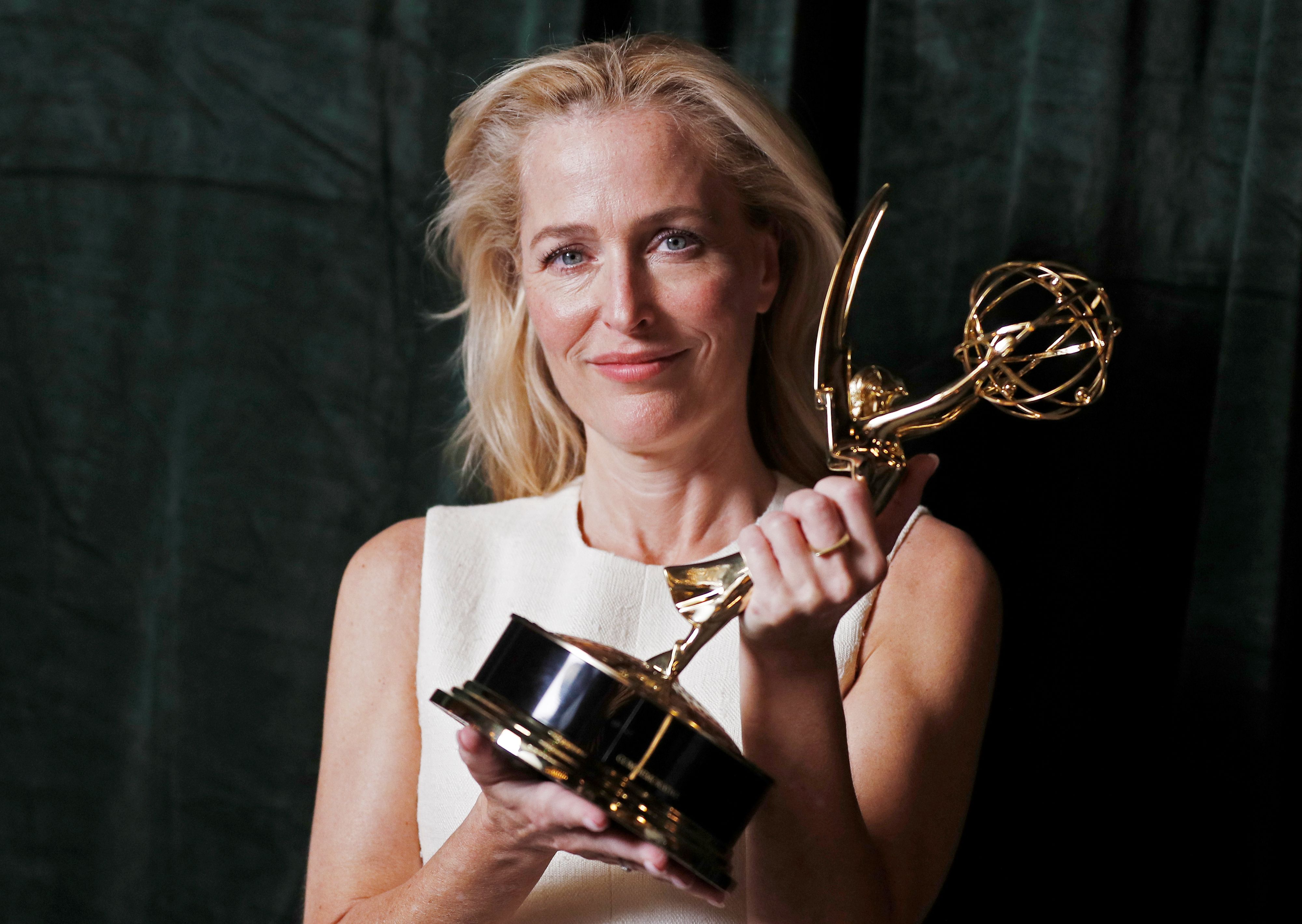 Gillian Anderson poses with her Emmy award for Outstanding Supporting Actress in a Drama Series, backstage at the Netflix UK Primetime Emmy for "The Crown", in London, Britain, September 20, 2021. REUTERS/Peter Nicholls
