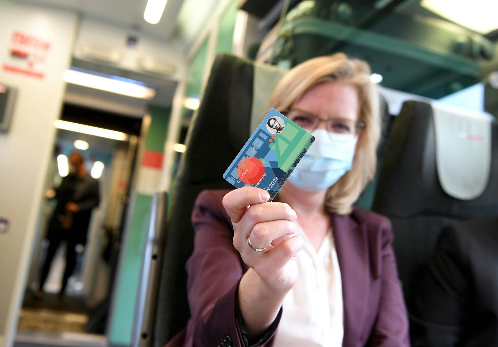 Infrastrukturministerin Leonore Gewessler (Grüne) mit einem Muster des "Klimaticket Ö" (1-2-3-Ticket) in einem Zug der ÖBB am Weg nach Linz am Mittwoch.