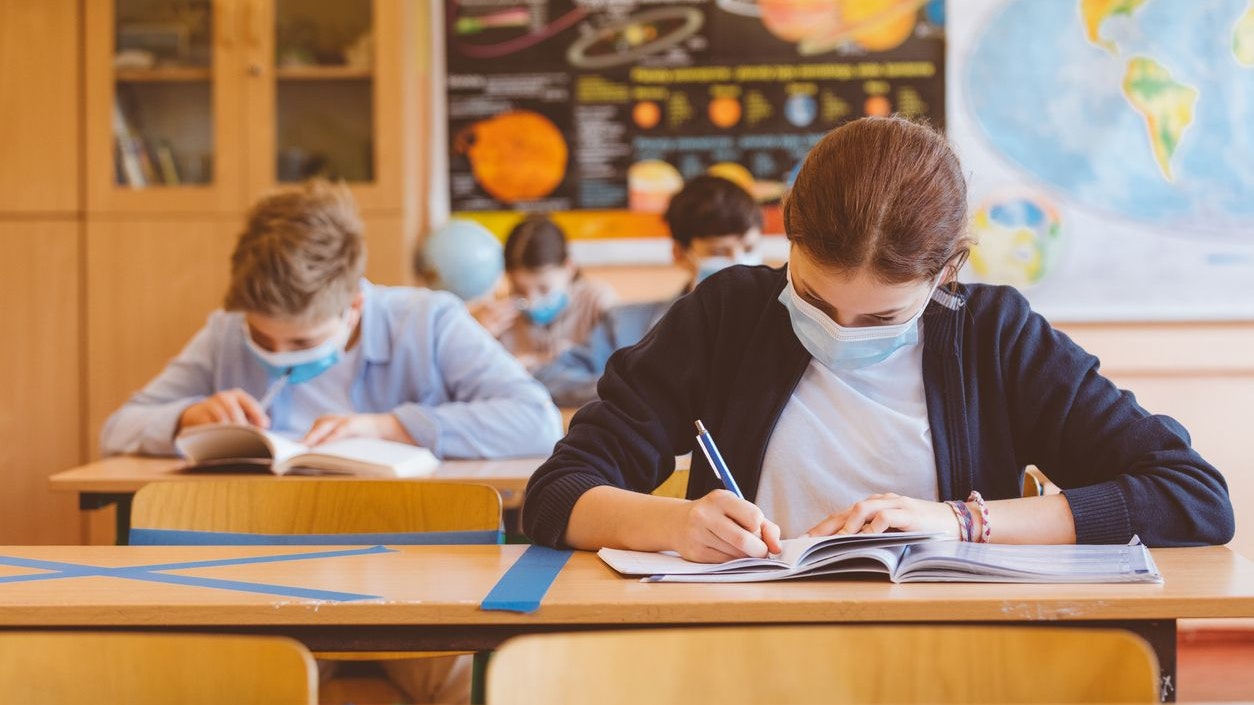 High school students at school, wearing N95 Face masks. Sitting in a classroom.