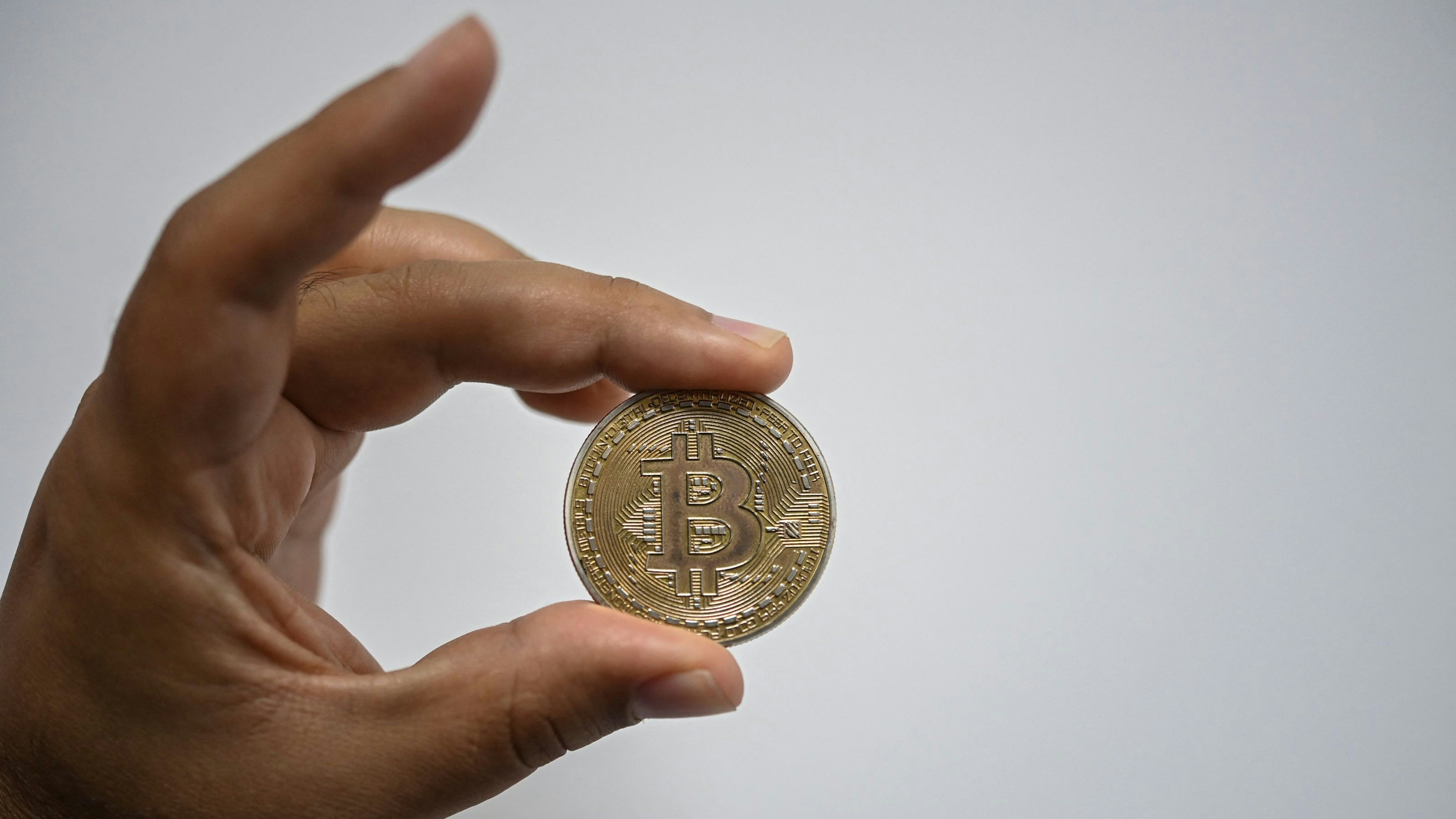 Download von www.picturedesk.com am 29.09.2021 (09:23).  A man shows a souvenir coin depicting a bitcoin in Caracas on September 17, 2021. - According to a study by several universities, 96% of the population lives in poverty so video games that involve non-fungible tokens (NFTs) have unleashed a boom among the population that dreams with having a plant (Plant Vs Undead) that allows them to earn a bitcoin to get out of poverty. (Photo by Yuri CORTEZ / AFP) - 20210917_PD16202 - Rechteinfo: Rights Managed (RM) Nur für redaktionelle Nutzung! Werbliche Nutzung erfordert Freigabe: bitte schicken Sie uns eine Anfrage.