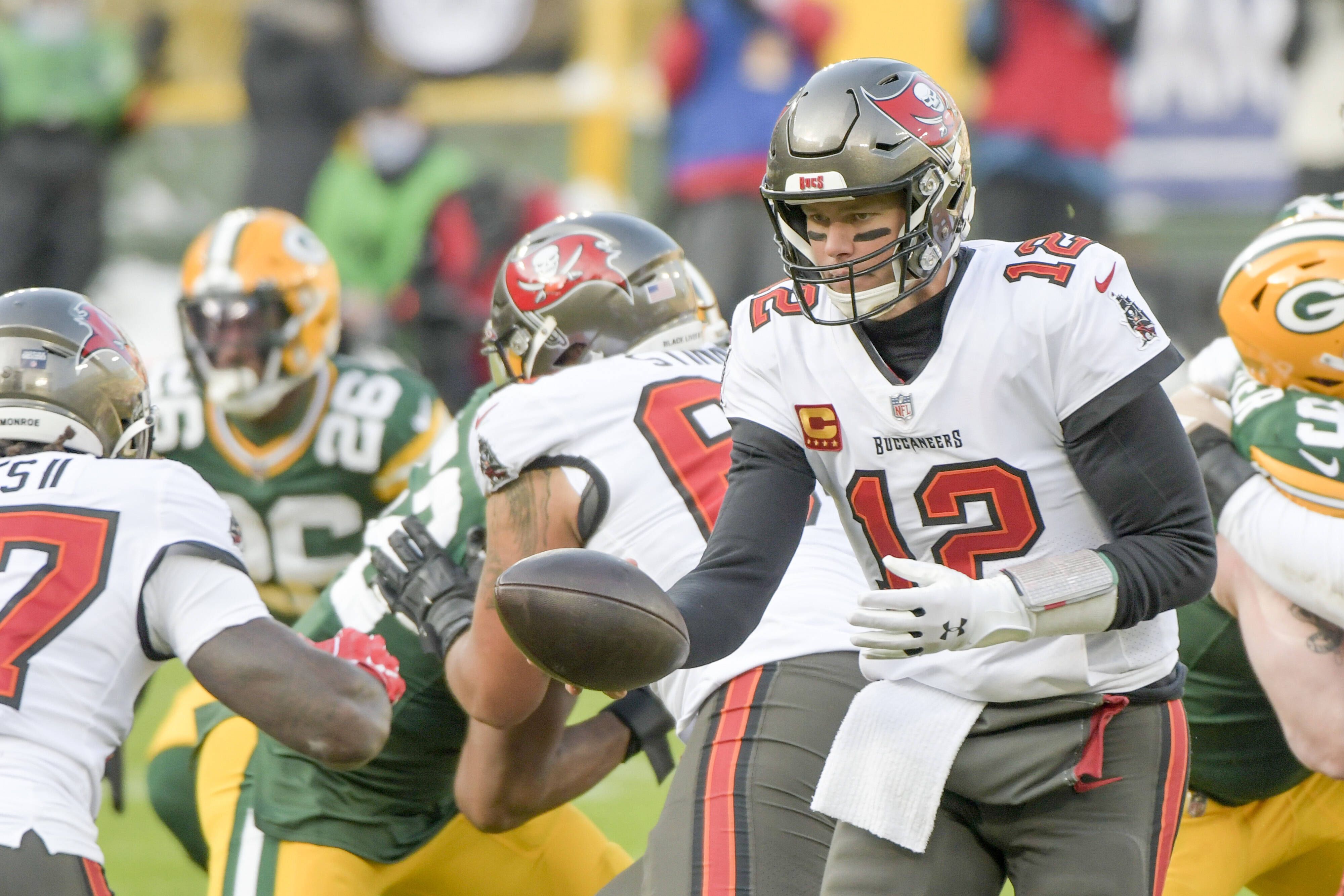  Tampa Bay Buccaneers quarterback Tom Brady 12 hands off the ball during in the first half of the NFC Championship against the Green Bay Packers at Lambeau Field in Green Bay, Wisconsin on Sunday, January 24, 2021. PUBLICATIONxINxGERxSUIxAUTxHUNxONLY GBA202101248 MARKxBLACK