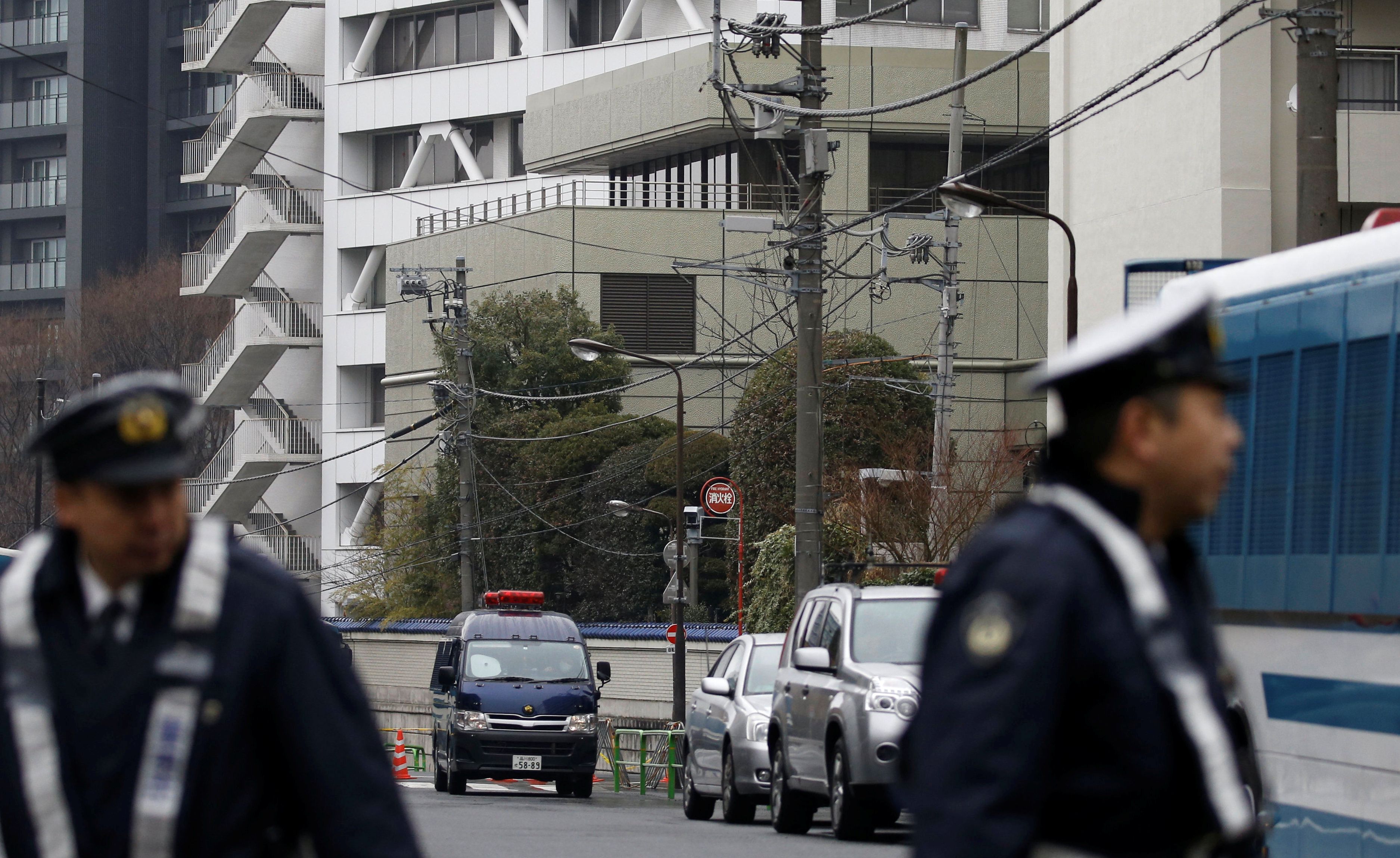 Police officers stand guard near the headquarters of the General Association of Korean Residents in Japan (Chongryon), after police arrested two men suspected of shooting in to the building in Tokyo, Japan, February 23, 2018. REUTERS/Toru Hanai