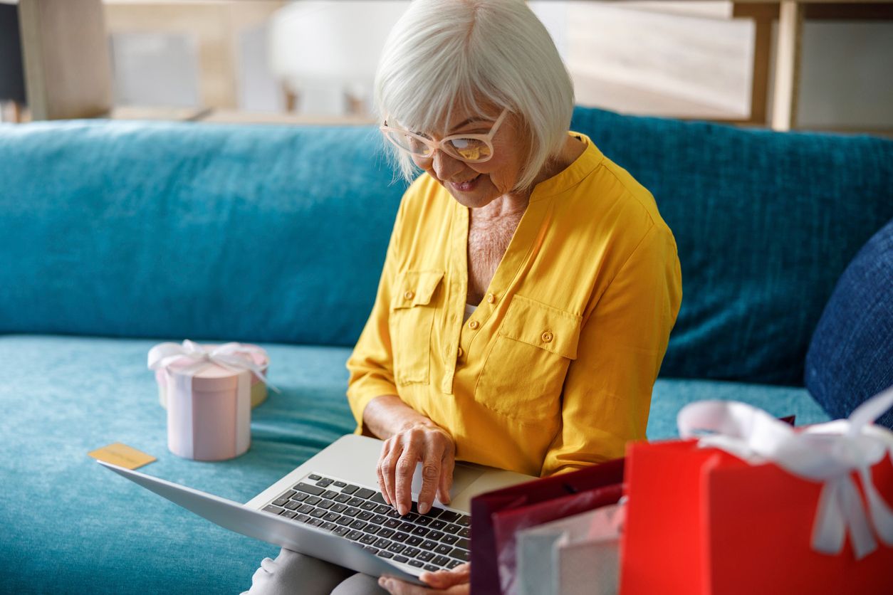 Mature lady in glasses holding gadget stock photo