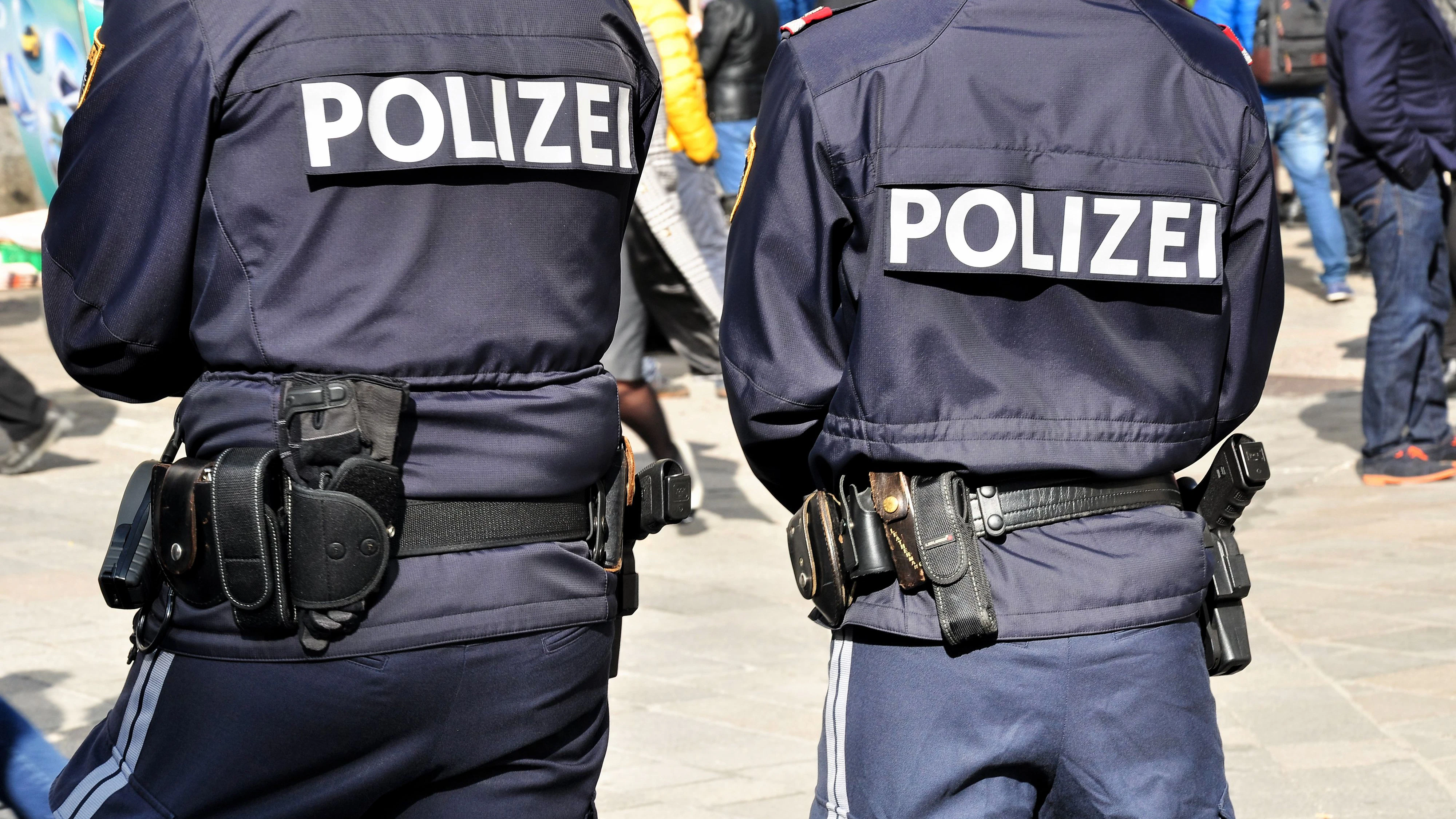 Backview of two policemen on patrol in vienna city