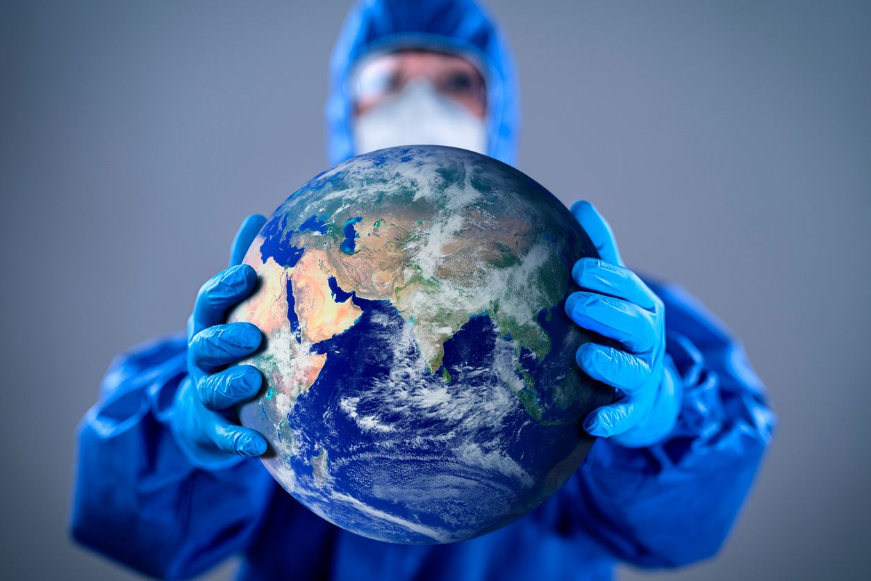 Doctor wearing highly protective suit and holding globe in her hands. Globe link: https://visibleearth.nasa.gov/images/2181/the-blue-marble/2182w