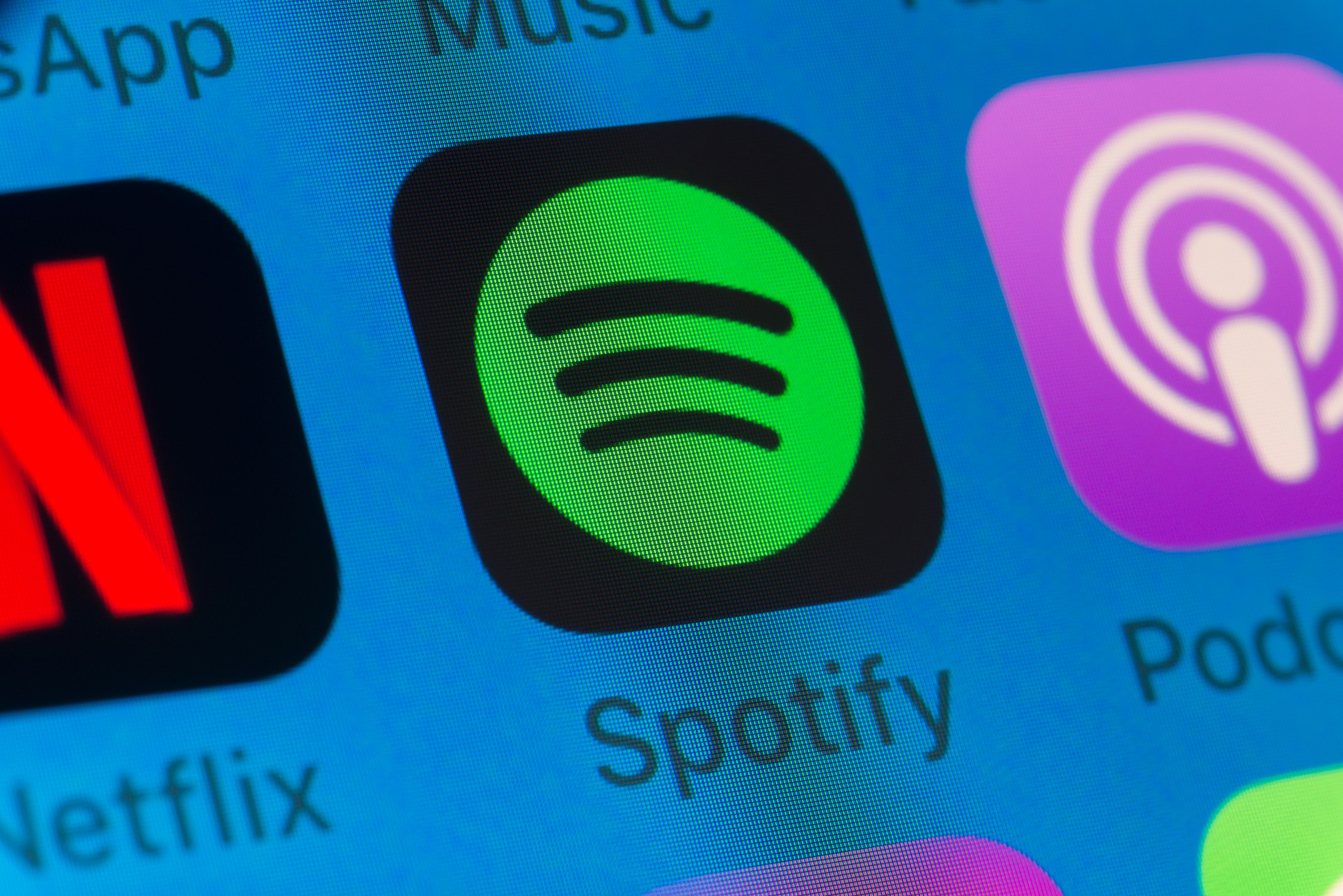 London, UK - August 01, 2018: The buttons of Spotify, Podcasts, Netflix, WhatsApp and Music on the screen of an iPhone.