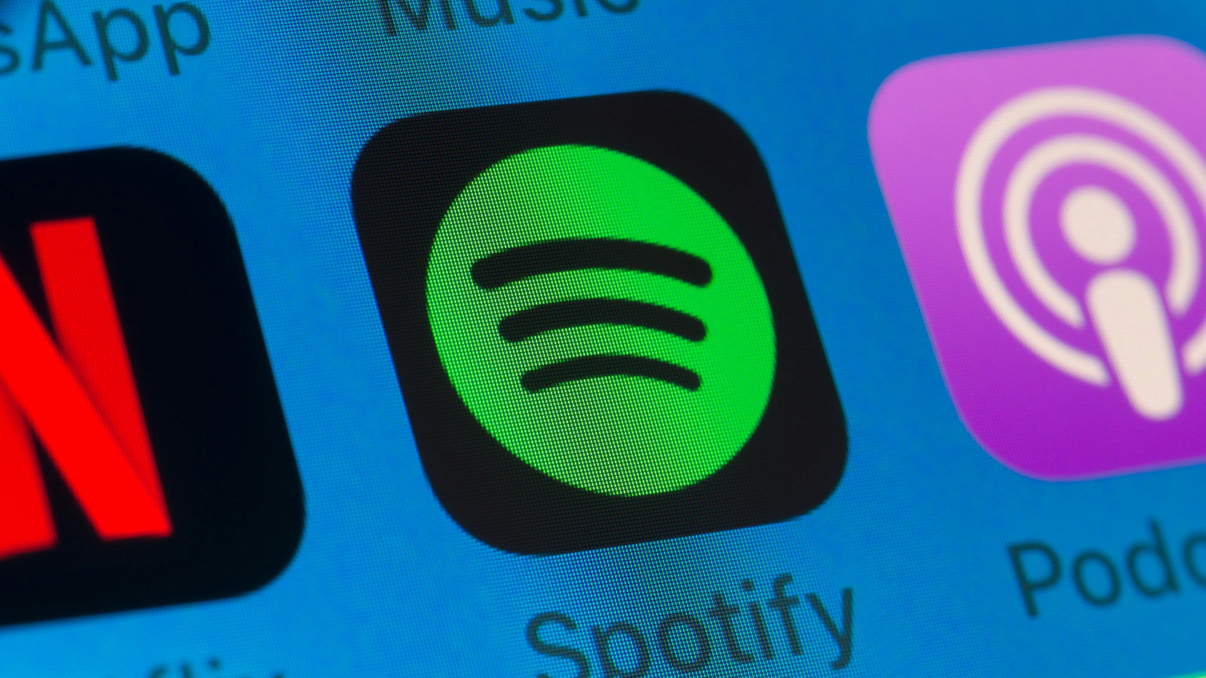 London, UK - August 01, 2018: The buttons of Spotify, Podcasts, Netflix, WhatsApp and Music on the screen of an iPhone.