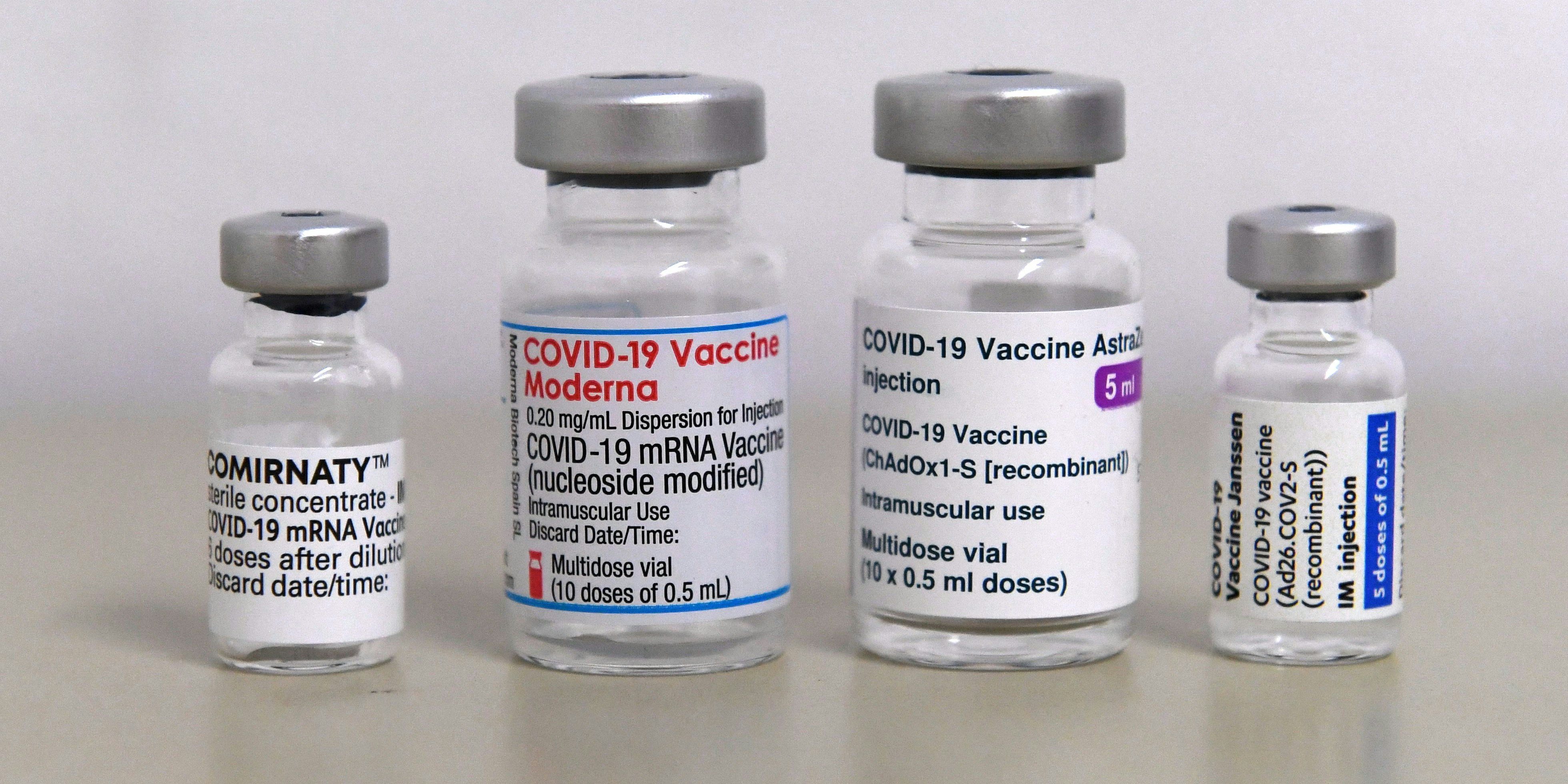 Empty vials of the COVID-19 vaccines against the novel coronavirus of several producers (L-R) Comirnaty by Pfizer / BioNTech, Moderna, AstraZeneca and Janssen by Johnson & Johnson are seen on a table in a vaccination center in Sonthofen, southern Germany, on November 30, 2021, amid the ongoing coronavirus Covid-19 pandemic. - Germany's incoming chancellor Olaf Scholz on November 30, 2021 signalled his backing for mandatory coronavirus jabs, a party source told AFP, as the country struggles to contain a fierce fourth wave of the pandemic. (Photo by Christof STACHE / AFP)