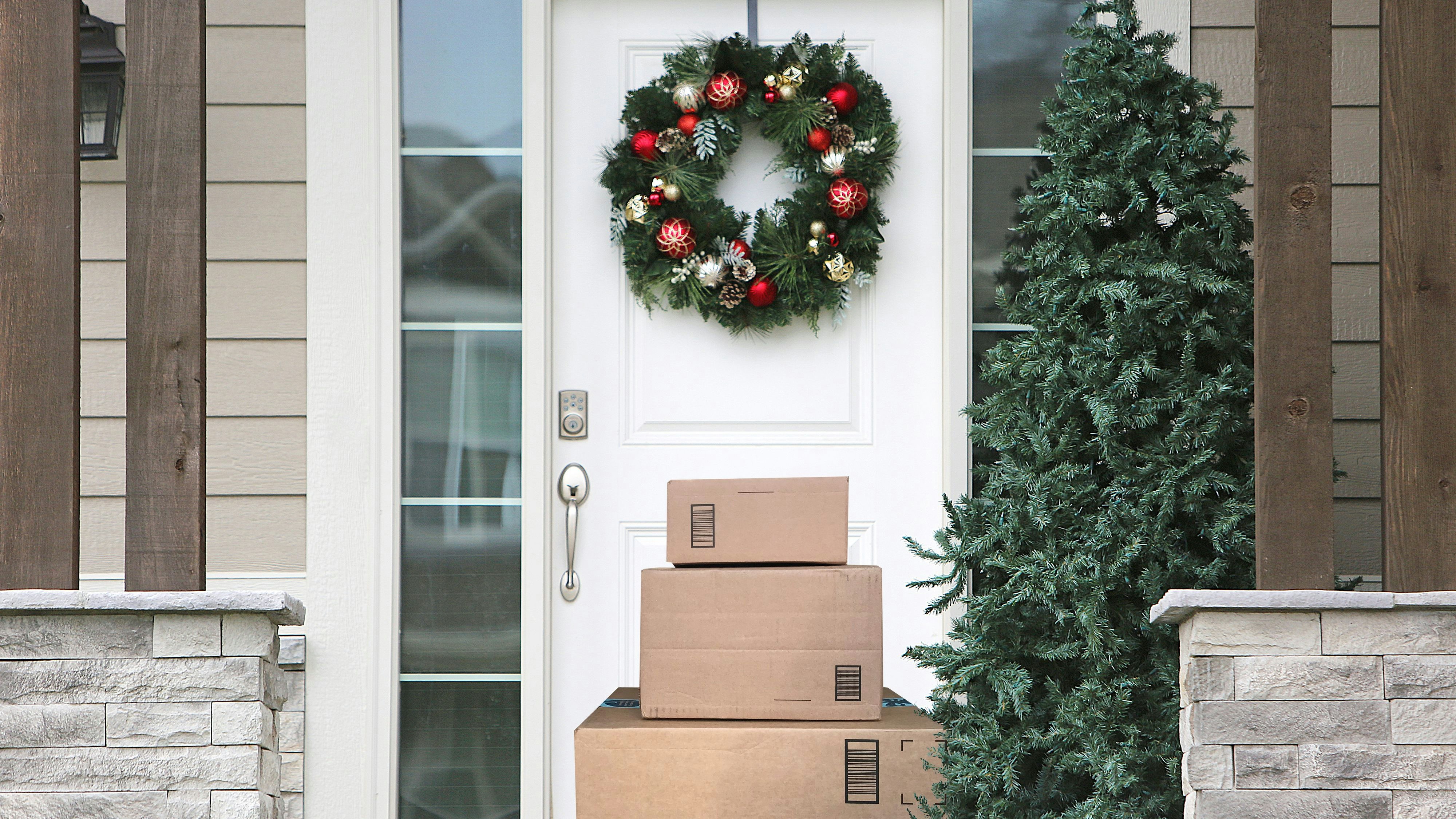 front door with christmas wreath and packages